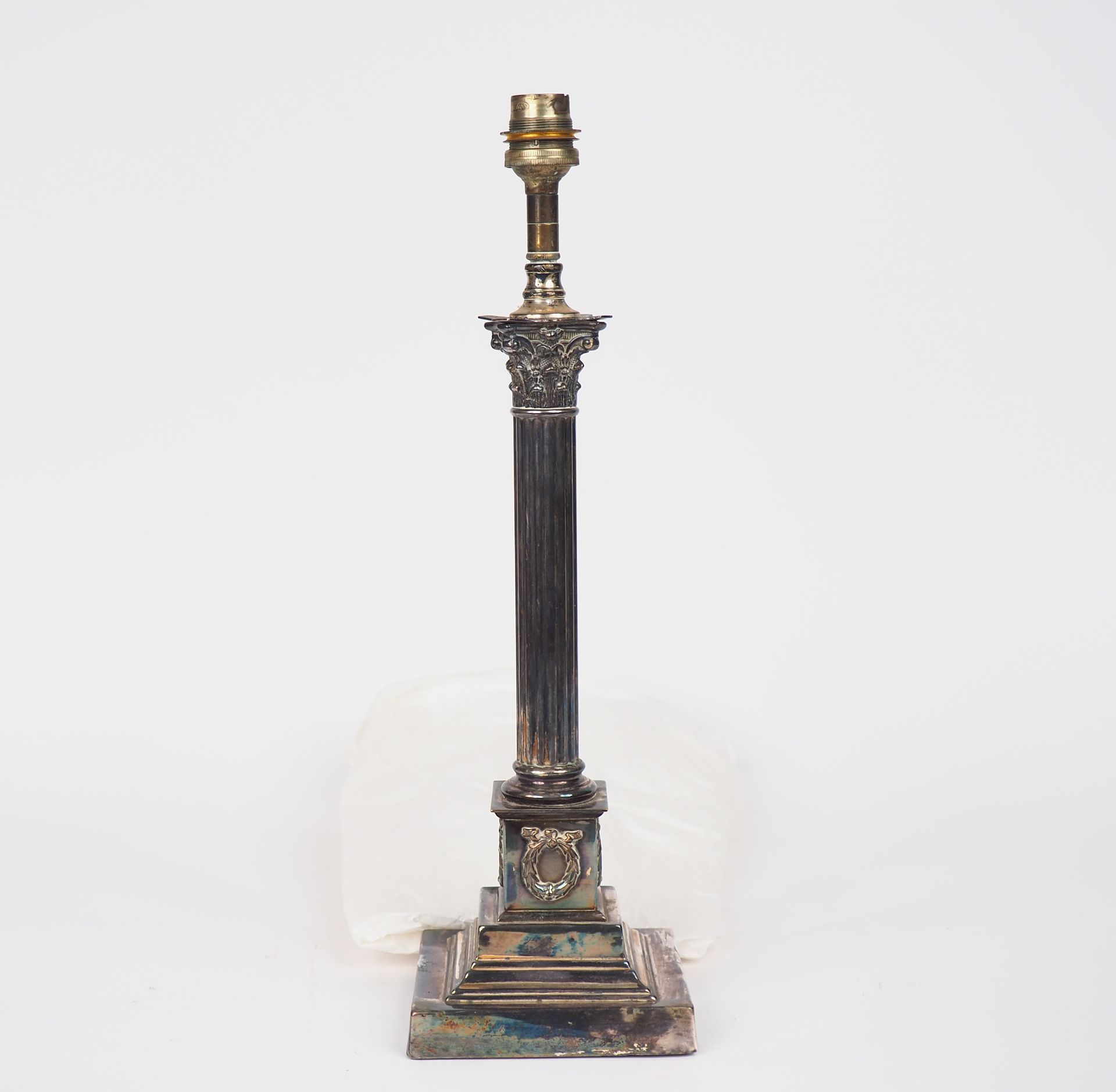 Null Lamp stand in silver plated metal in the shape of a Corinthian column.