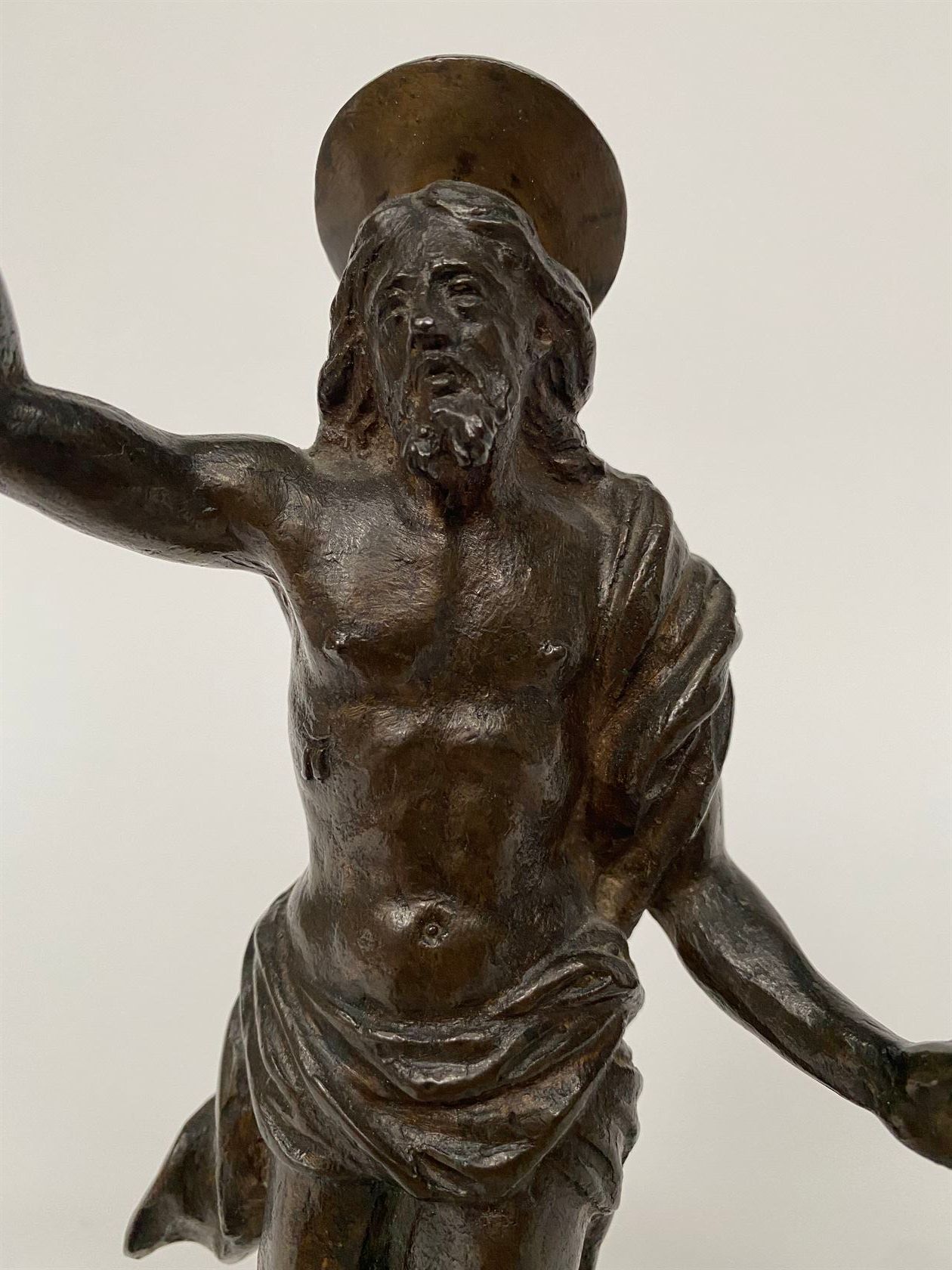 Null 一个带光环祝福的青铜基督，有美丽的铜锈，放在一个八角形的底座上（底座上有一个孔）。17世纪晚期。高23厘米。