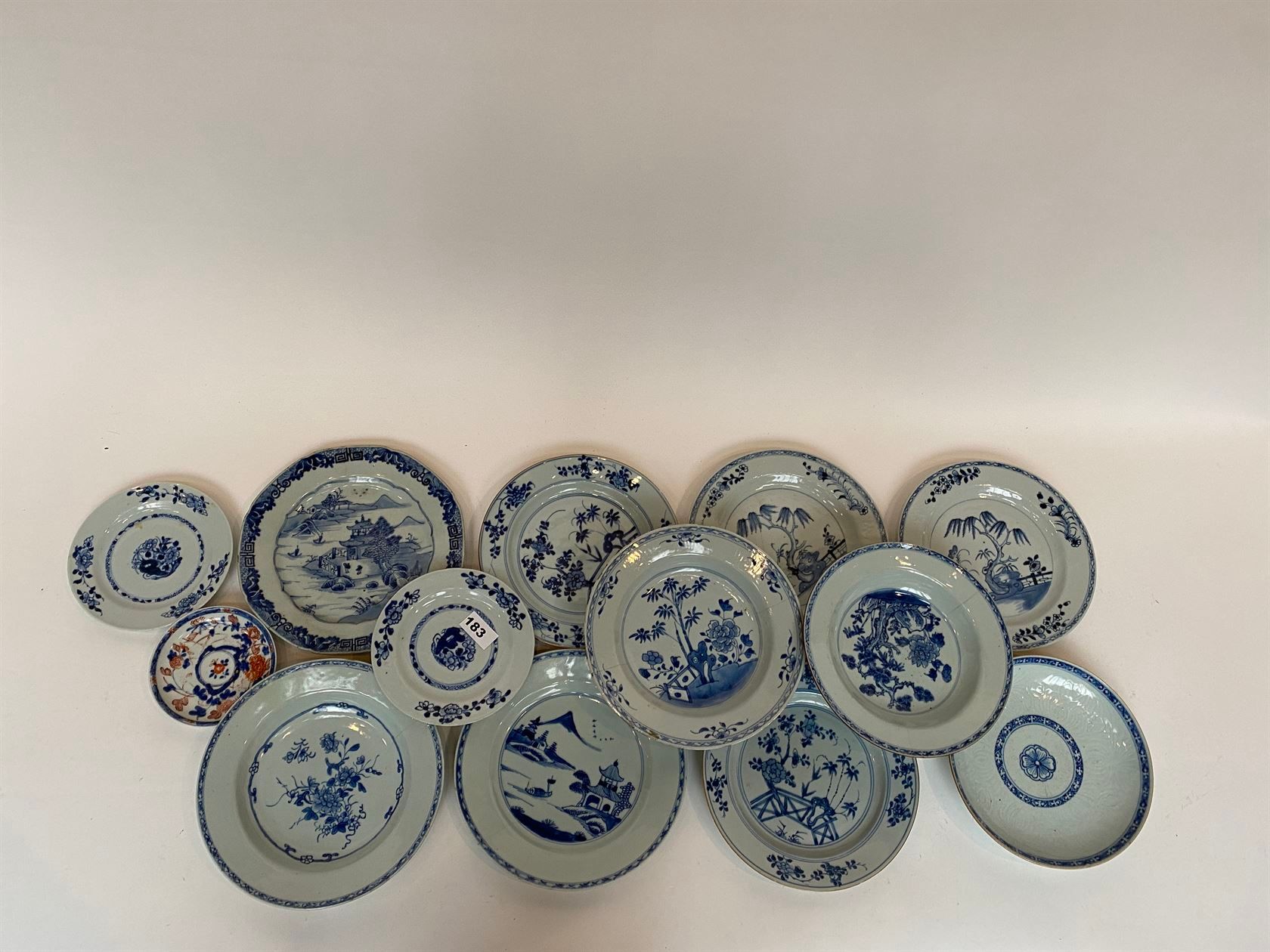 Null 一套10个瓷盘，釉下青花、植物和风景的装饰。附有两个小碗（有裂纹和缺陷）。中国，18世纪。直径约23厘米。