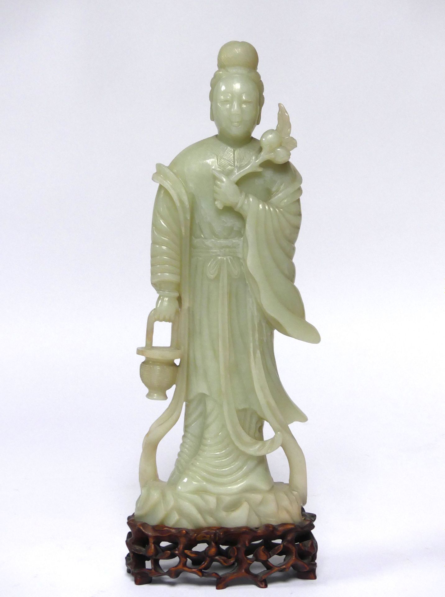 Null CHINA. GUANYIN with a branch, in green carved jade. H. 28 cm (Some chips)