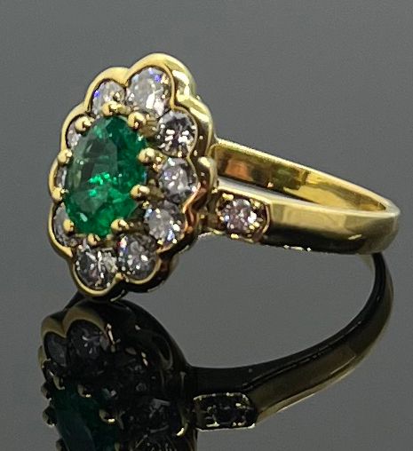 Null Yellow gold daisy ring set with an oval faceted emerald in a diamond settin&hellip;