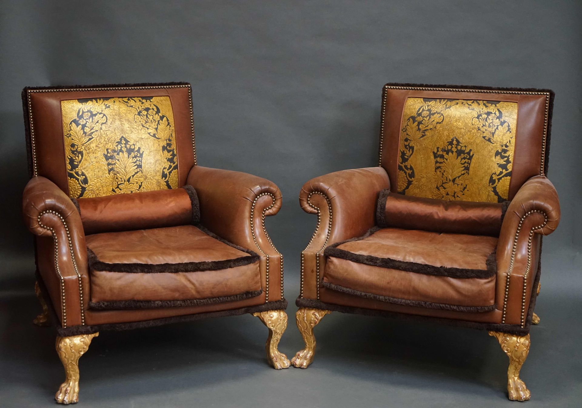 Null 一对用黄褐色皮革装饰的大型牧羊人椅，椅背饰有仿科尔多瓦皮革的黑底镀金刺桐叶图案，安放在四只雕有罗盖尔树叶的镀金木爪脚上。