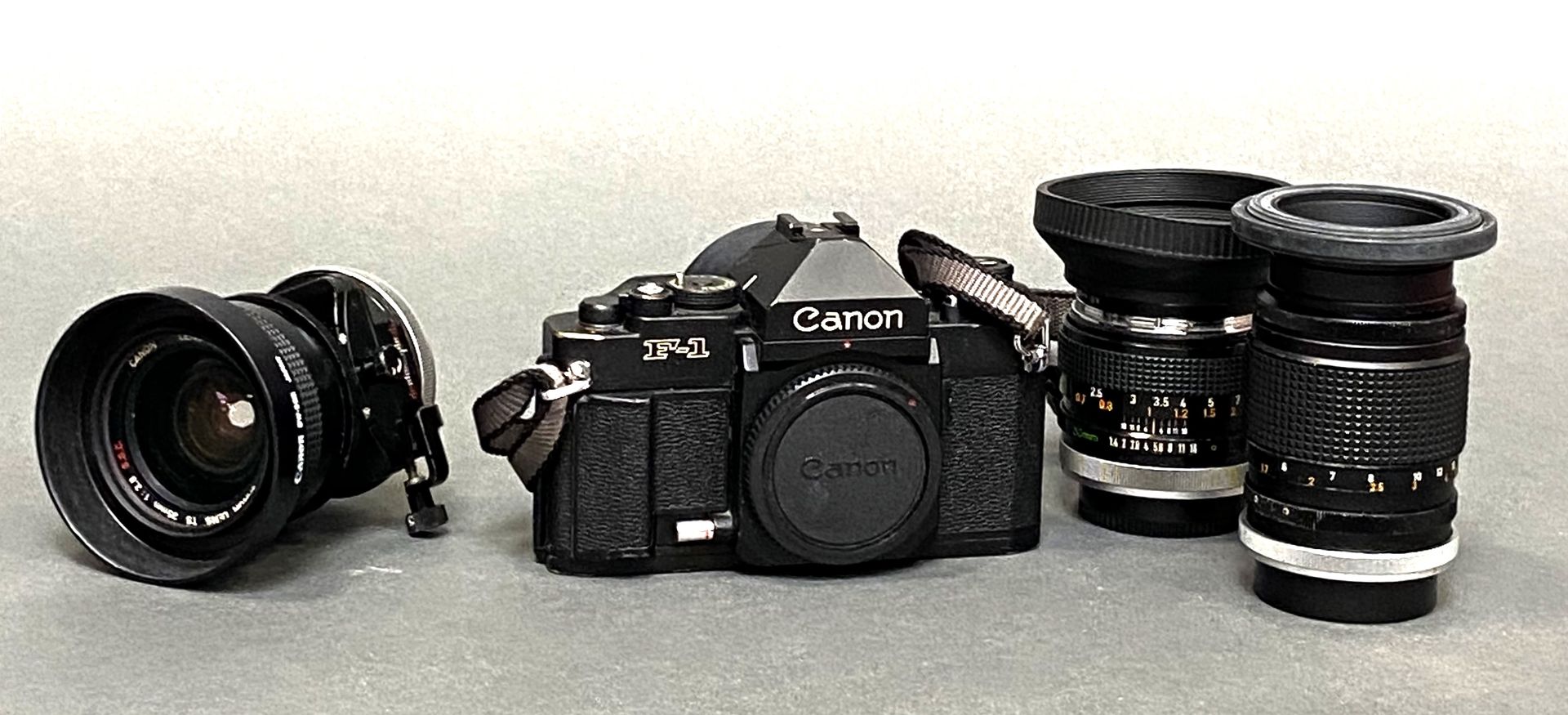 Null CANON F1 camera and three lenses. An EUMIG C3 CAMERA is included.