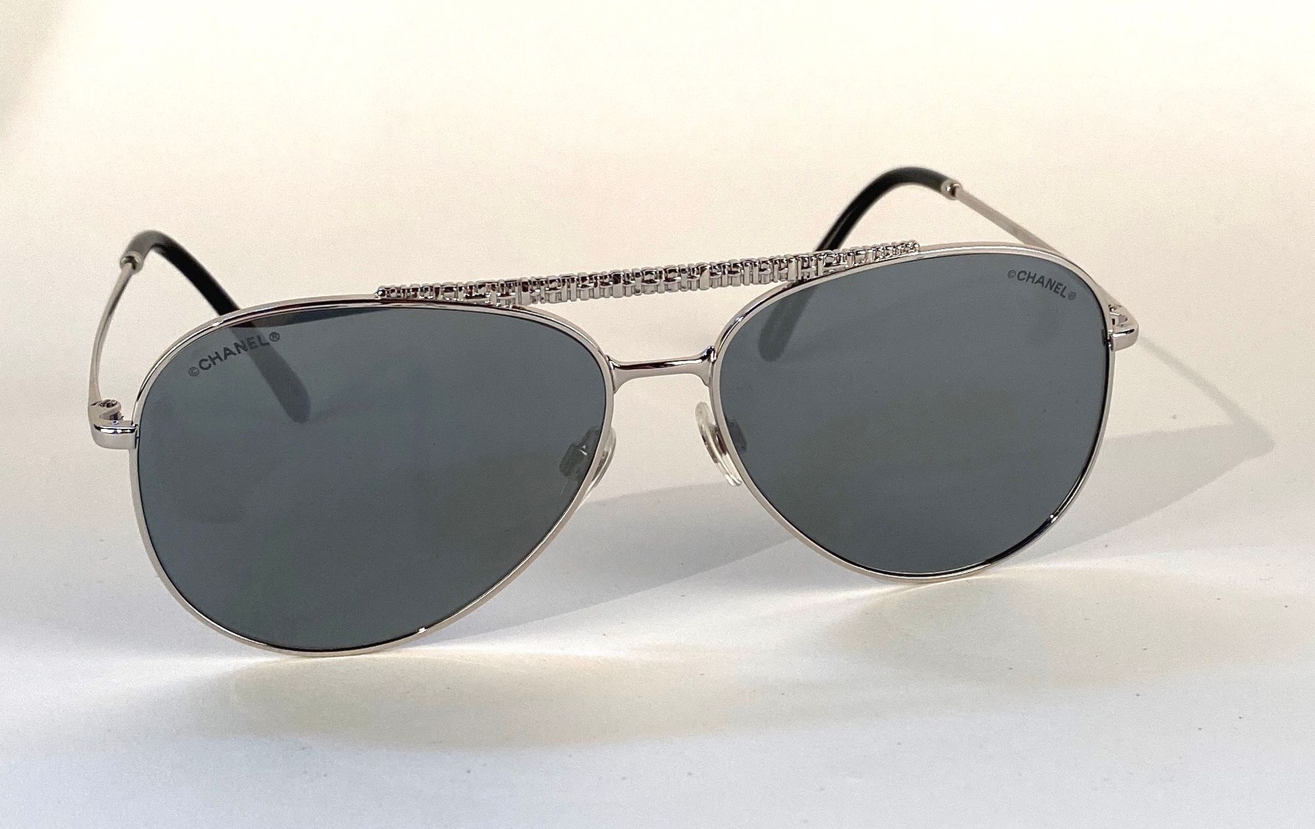 CHANEL. Pilot shape sunglasses with silver metal frame, …