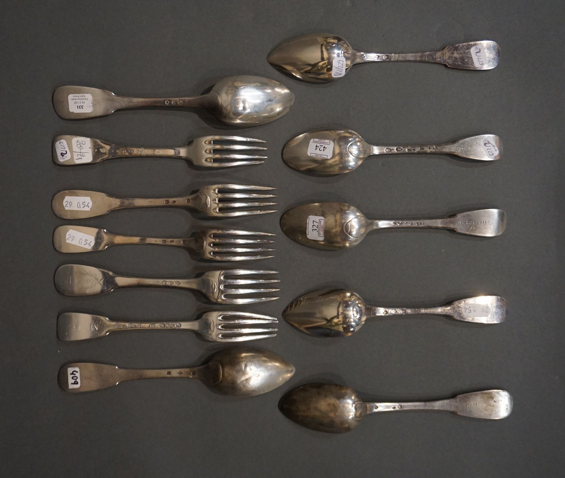 COUVERTS Seven large spoons and five large forks in plain silver, some emblazone&hellip;