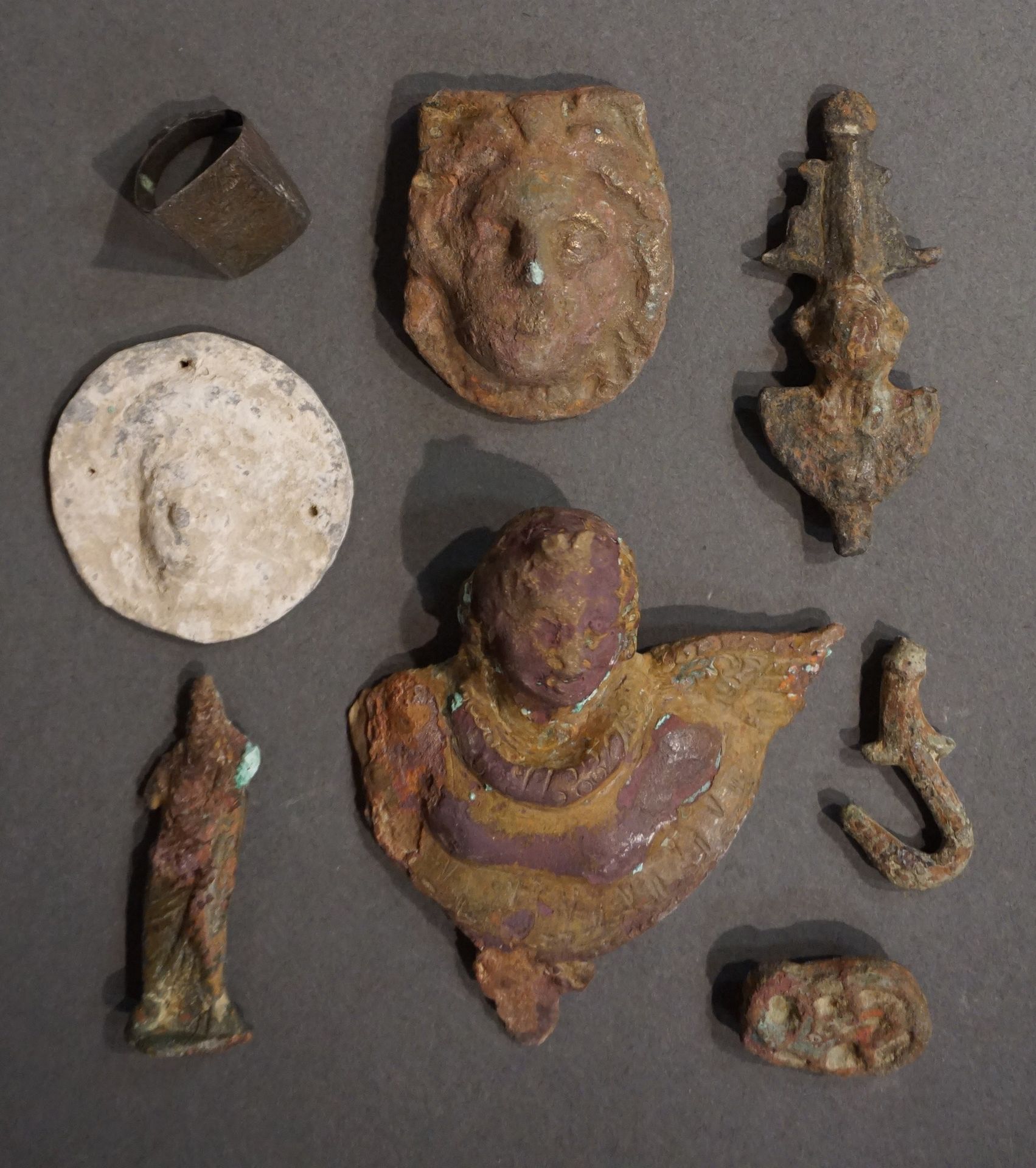 Null Lot including a lead discoid weight decorated with a female head, a medusa &hellip;