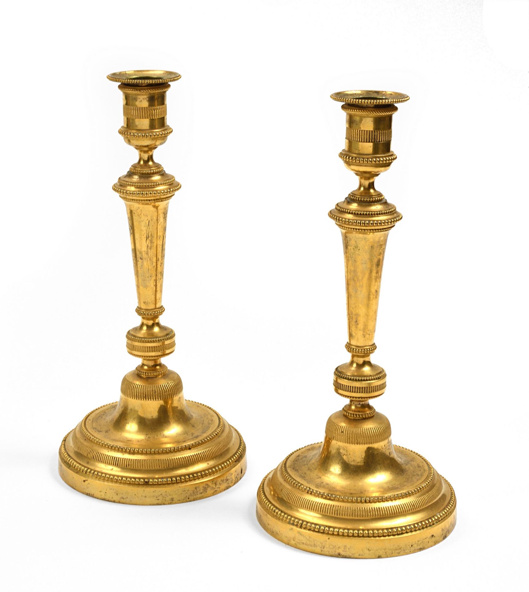 Null Pair of ormolu candlesticks, tapered shaft underlined by friezes of pearls &hellip;