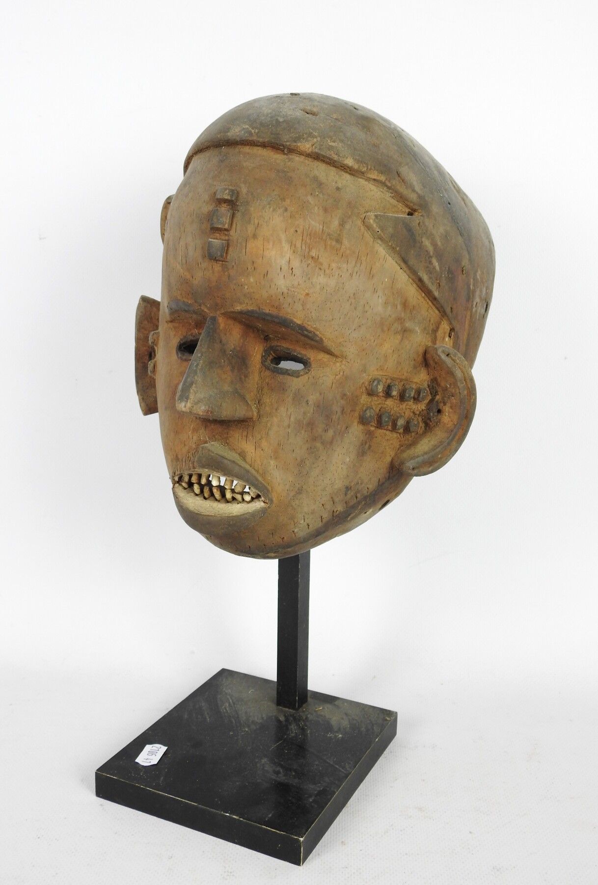 Null IDOMA Nigera :OKUA面具显示出一张额头隆起的脸，脸上有疤痕，张着嘴和竹子的牙齿。高度：26厘米。旧的缺失部分。



出处：凡尔赛拍卖&hellip;