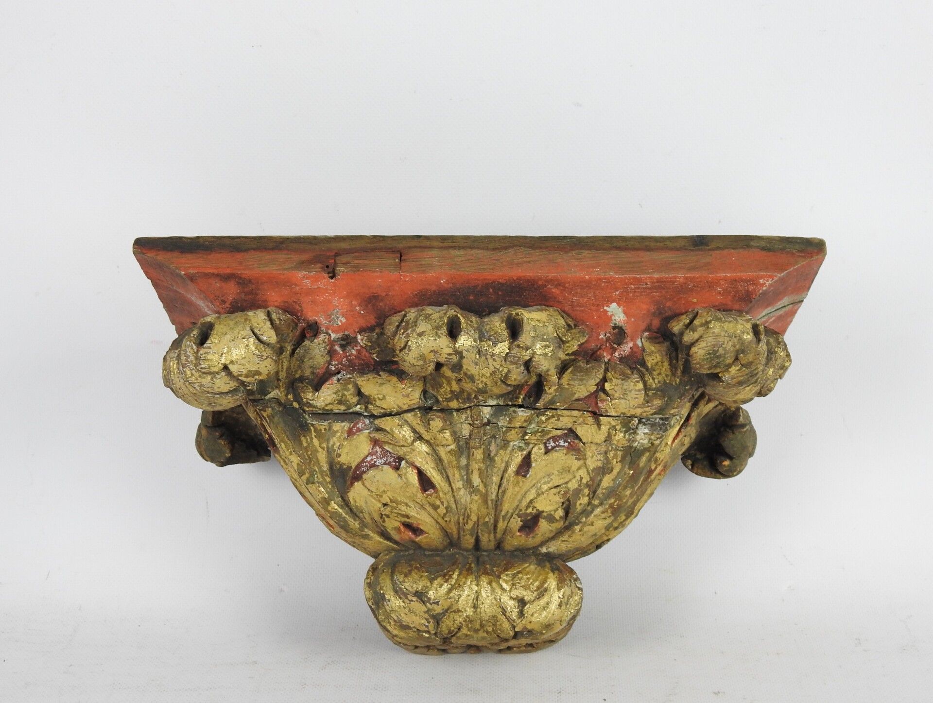 Null A carved, gilded and painted red wood wall console with acanthus leaf decor&hellip;