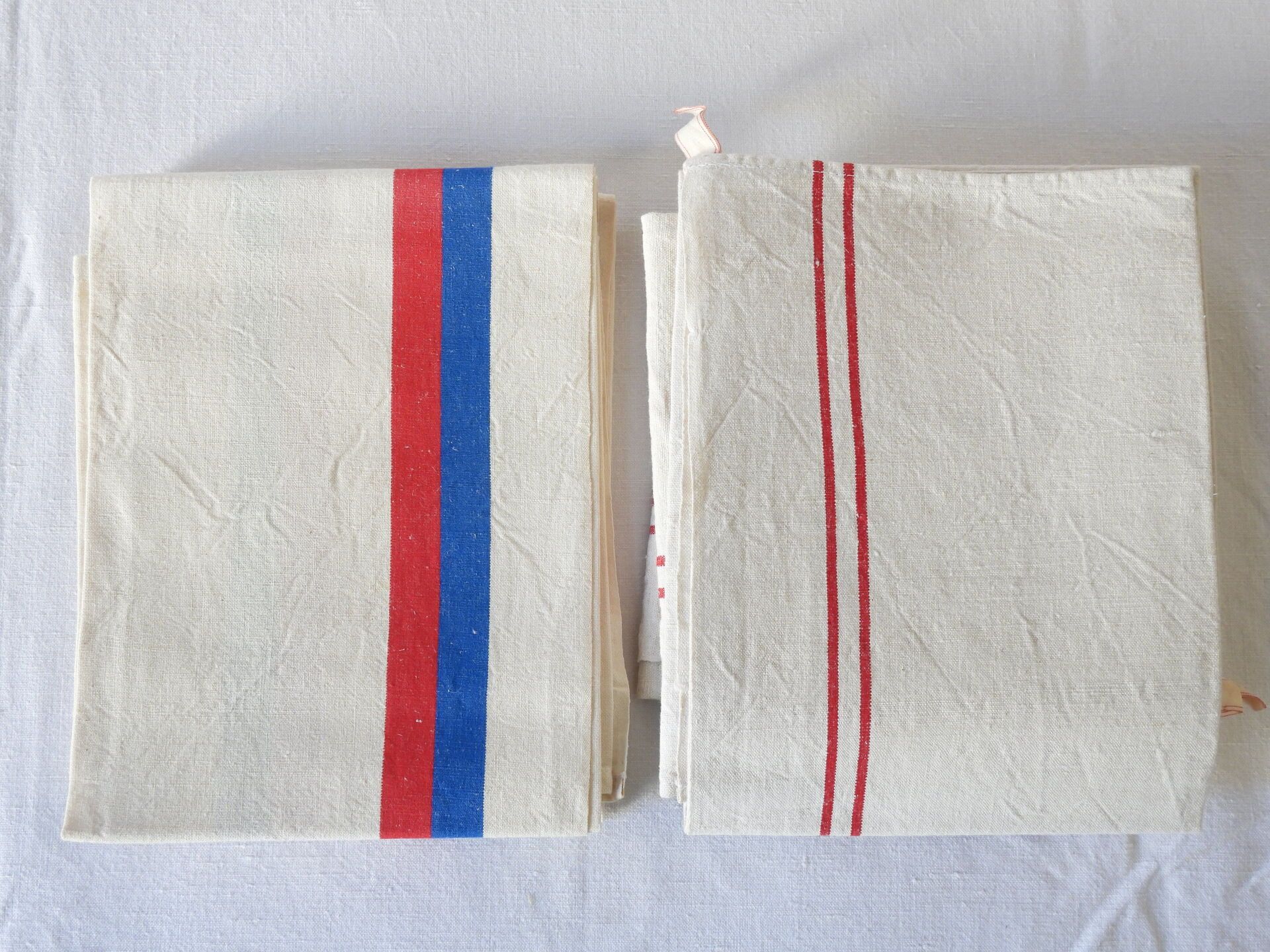 Null Six red striped tea towels & three blue & red striped.