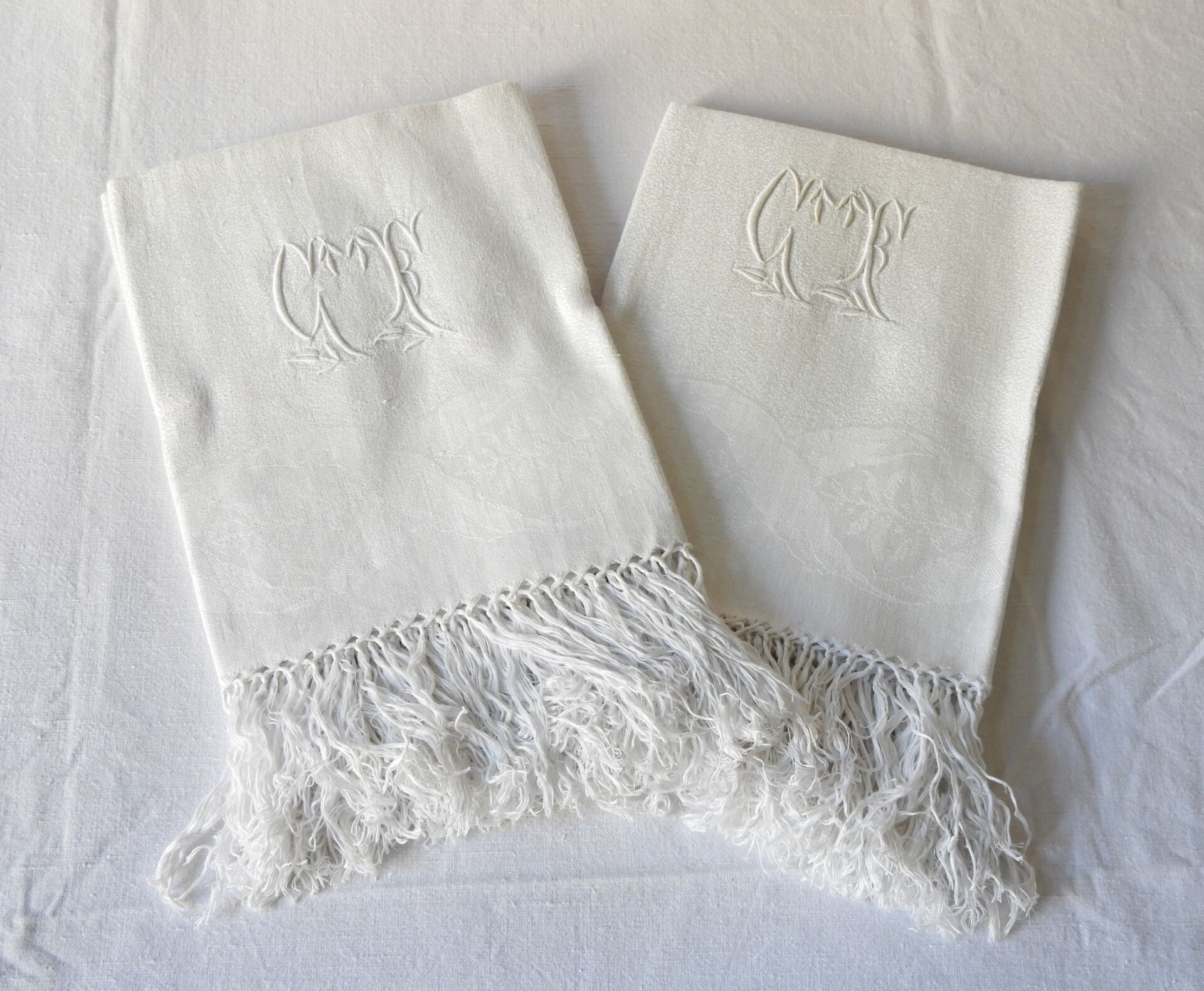 Null Four guest towels figured G.F. Damask border.