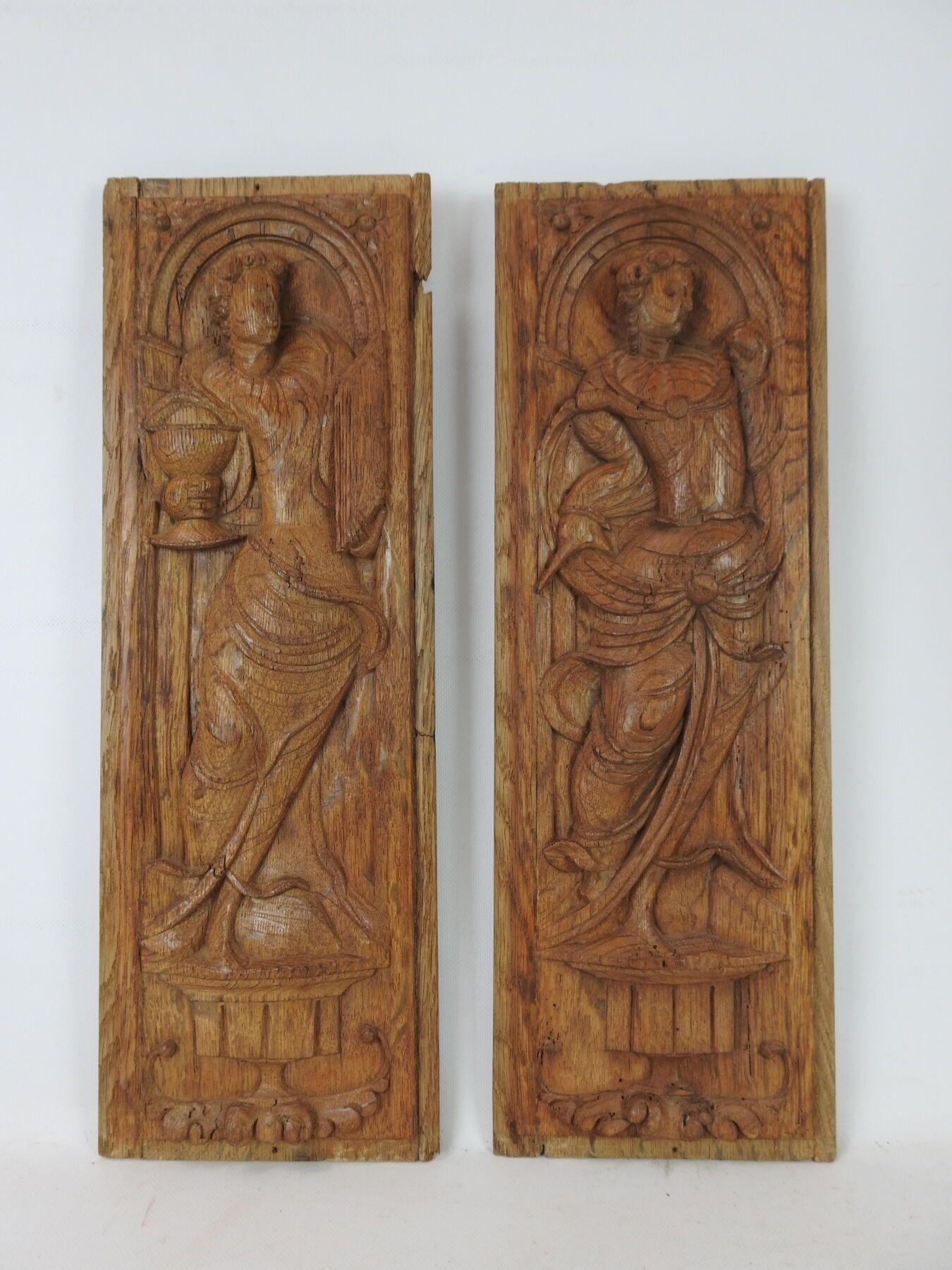 Null Pair of carved oak panels representing two theological virtues, Faith and C&hellip;