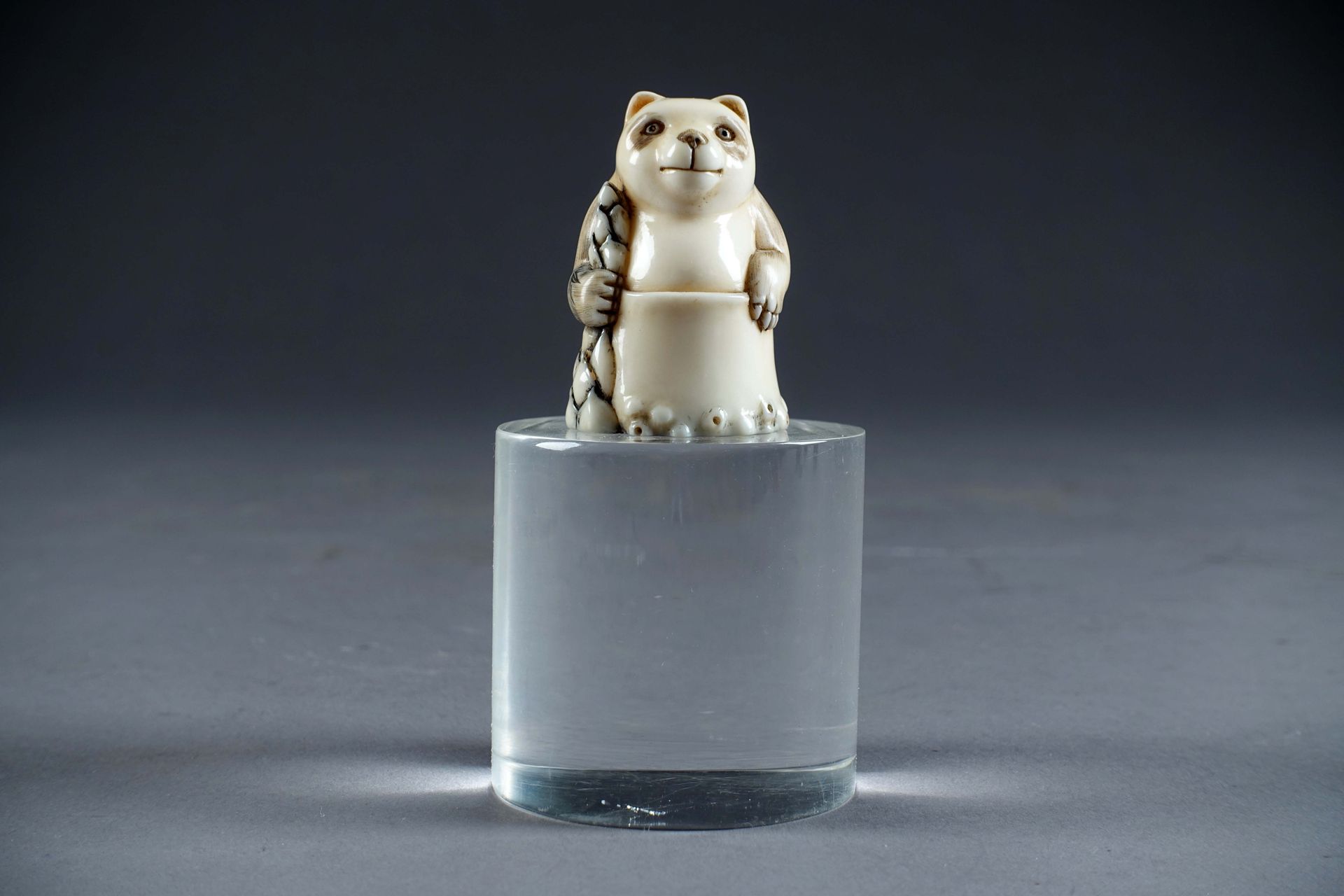 Rare Netsuké. Depicting a panda sitting in a pond. The base engraved with a pine&hellip;