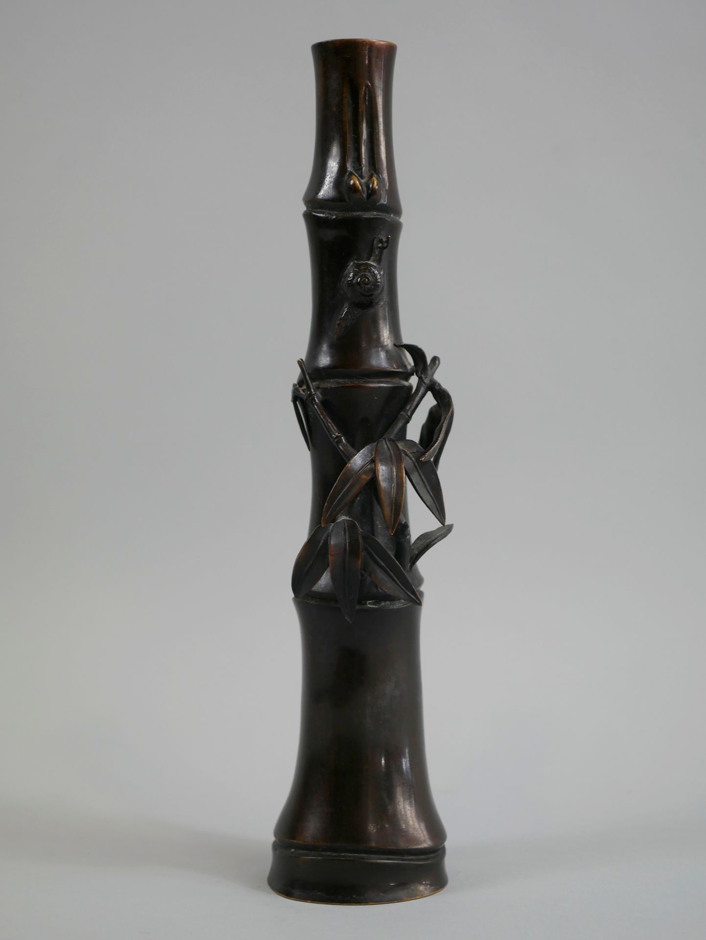 Null 日本。明治时期（1868-1912）。一件棕色的铜制花瓶，外形是一段竹子，有茎和叶子以及蜗牛。签名在脚上。高30厘米。