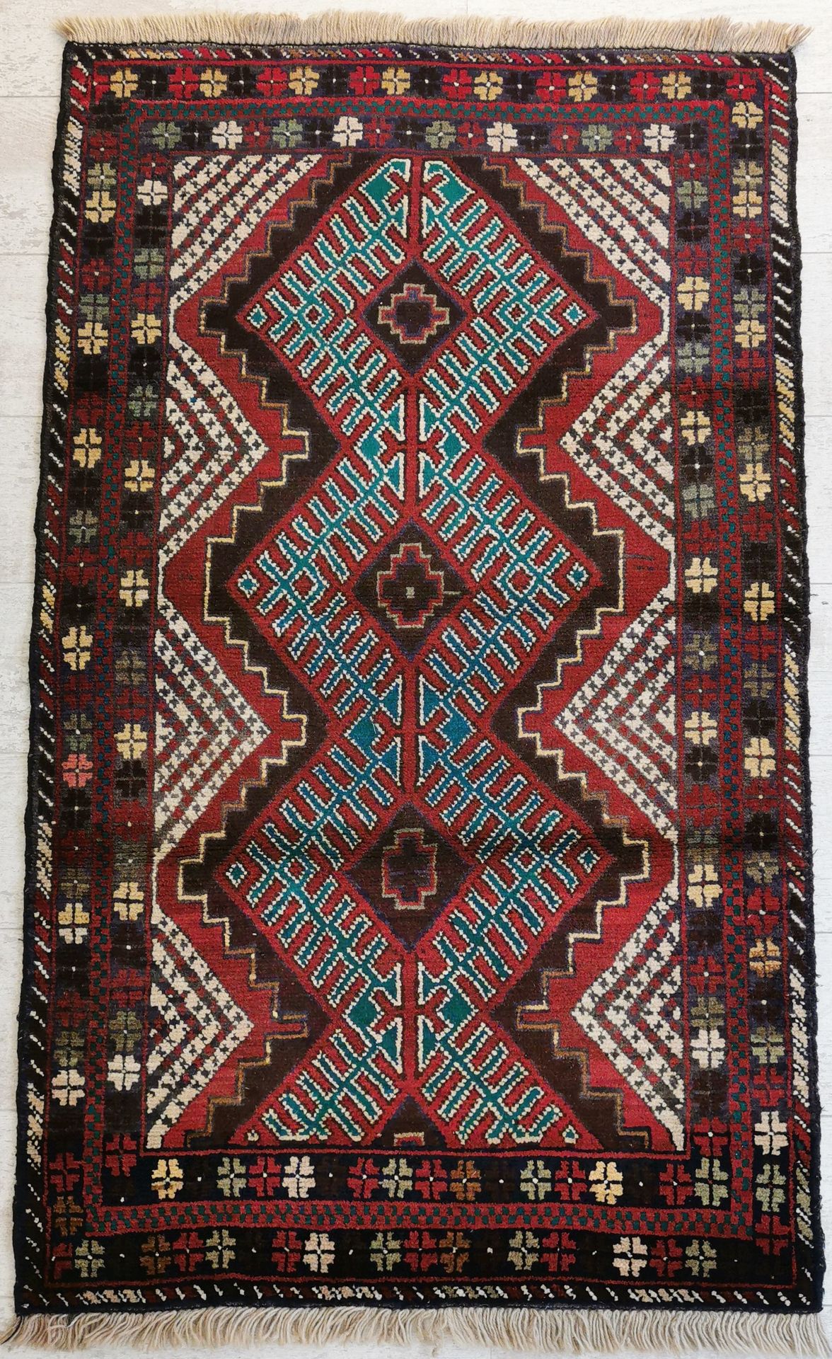 Null IRAN. Wool balouch carpet decorated with a central motif composed of three &hellip;