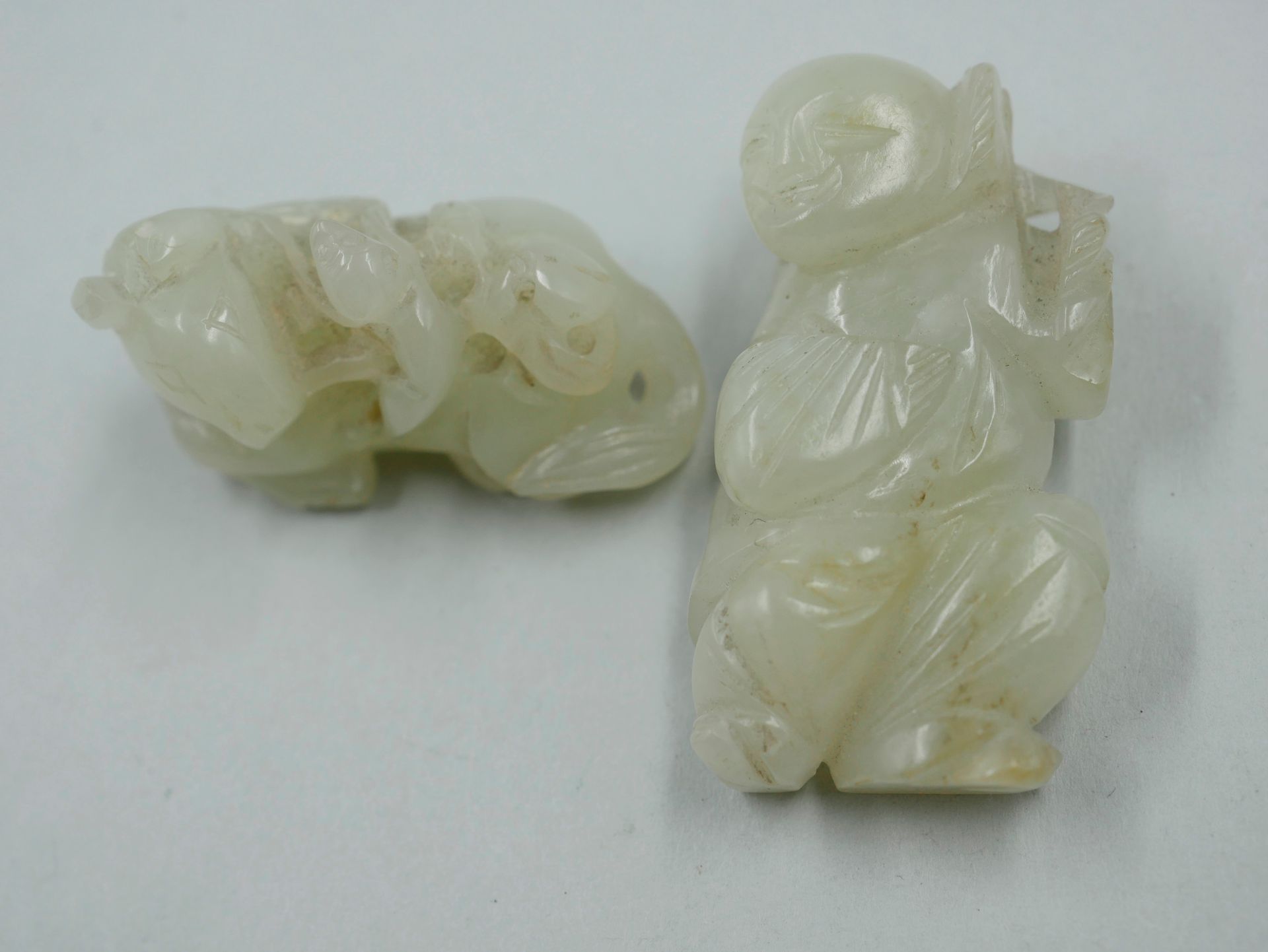 Null Two carved jade netsuke representing a reclining horse and a laughing chara&hellip;