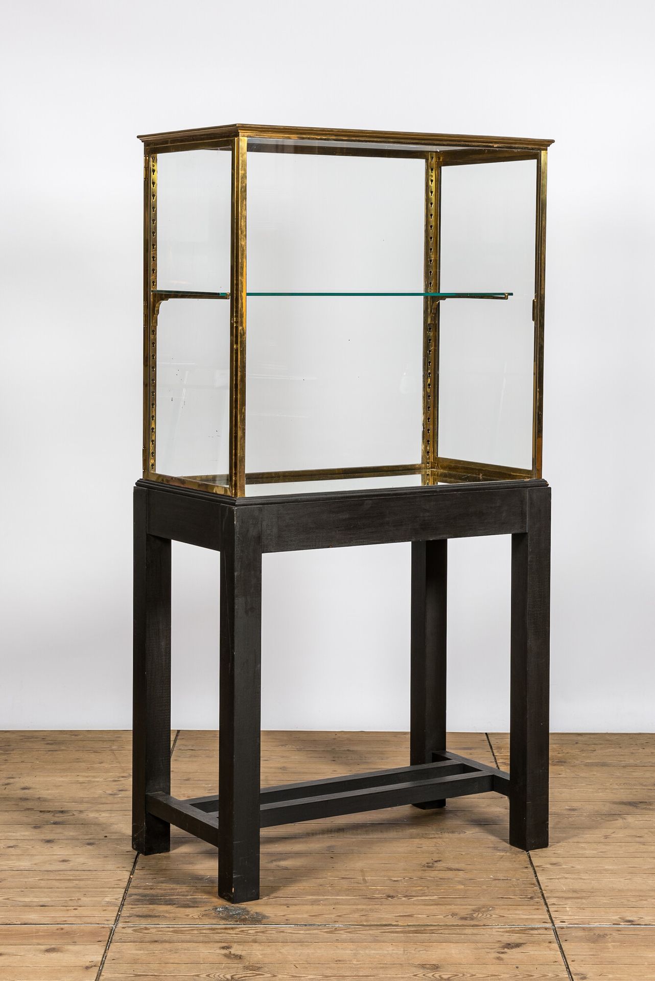 A French brass display cabinet on later wooden stand, 20th C. Full title: A Fren&hellip;