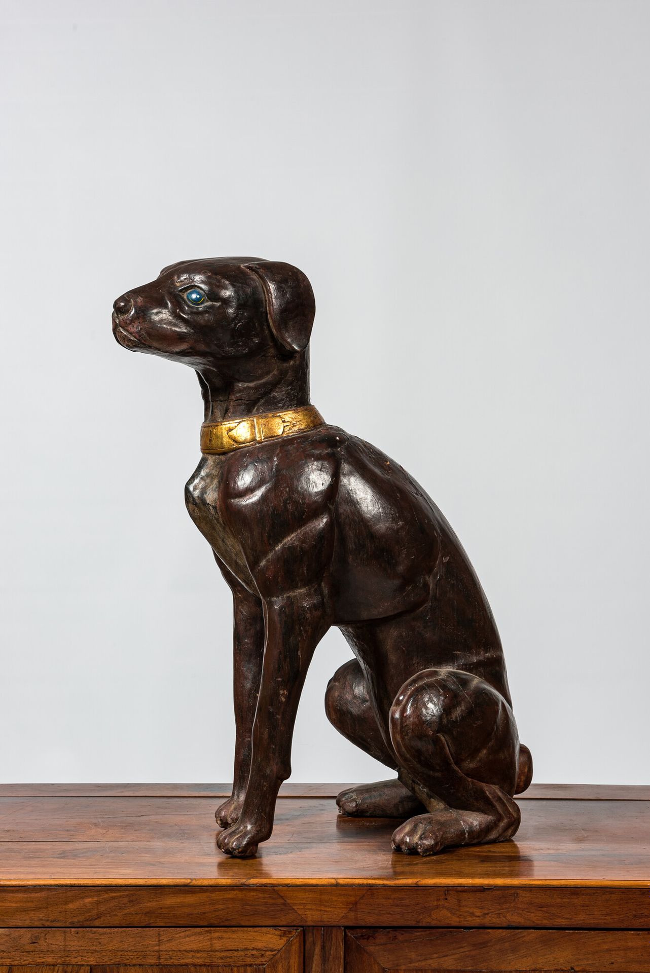 A large polychrome wooden sculpture of a dog, 1st half 20th C. Full title: A lar&hellip;