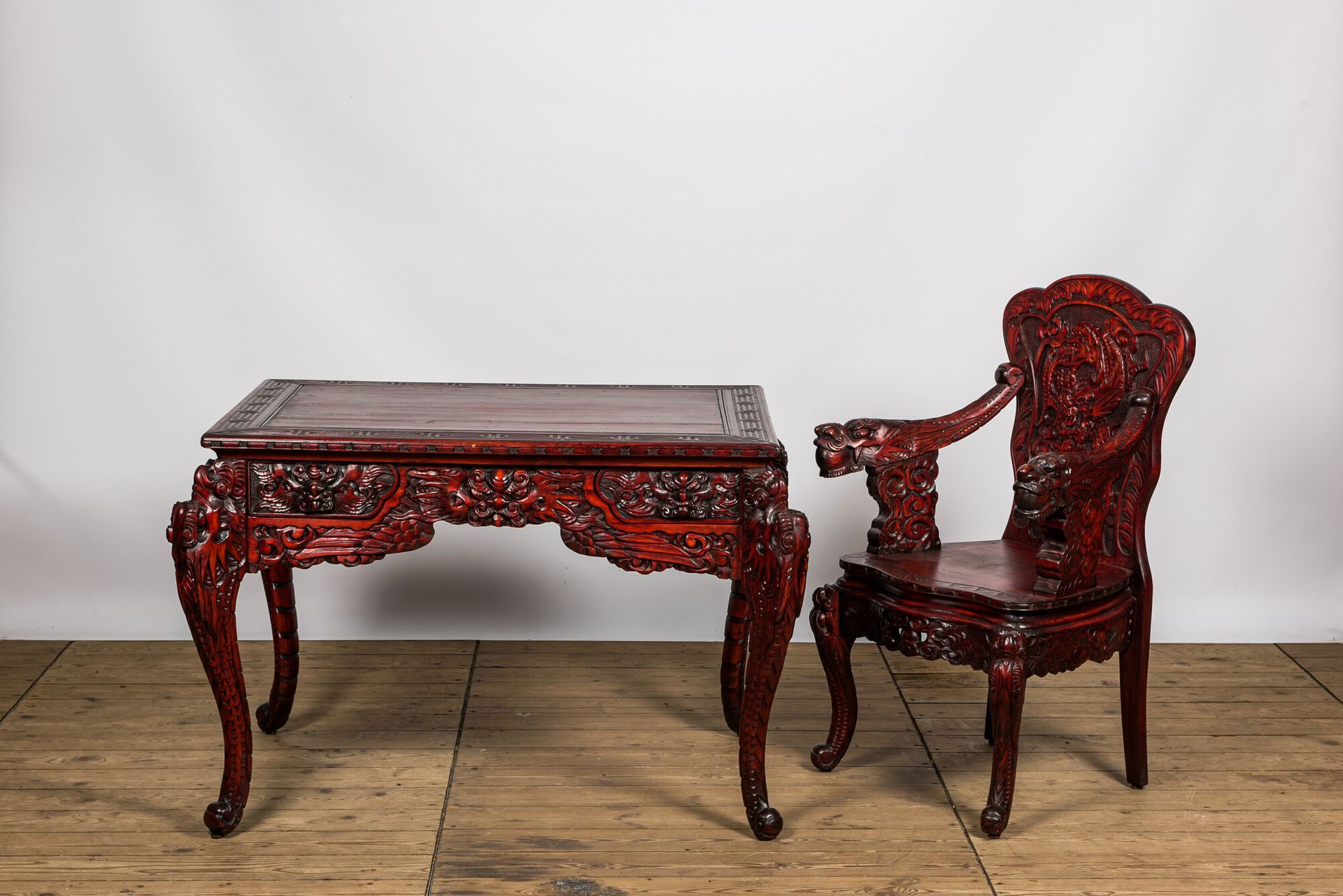 A finely carved Japanese red patinated wooden desk with armchair, 20th C. Full t&hellip;