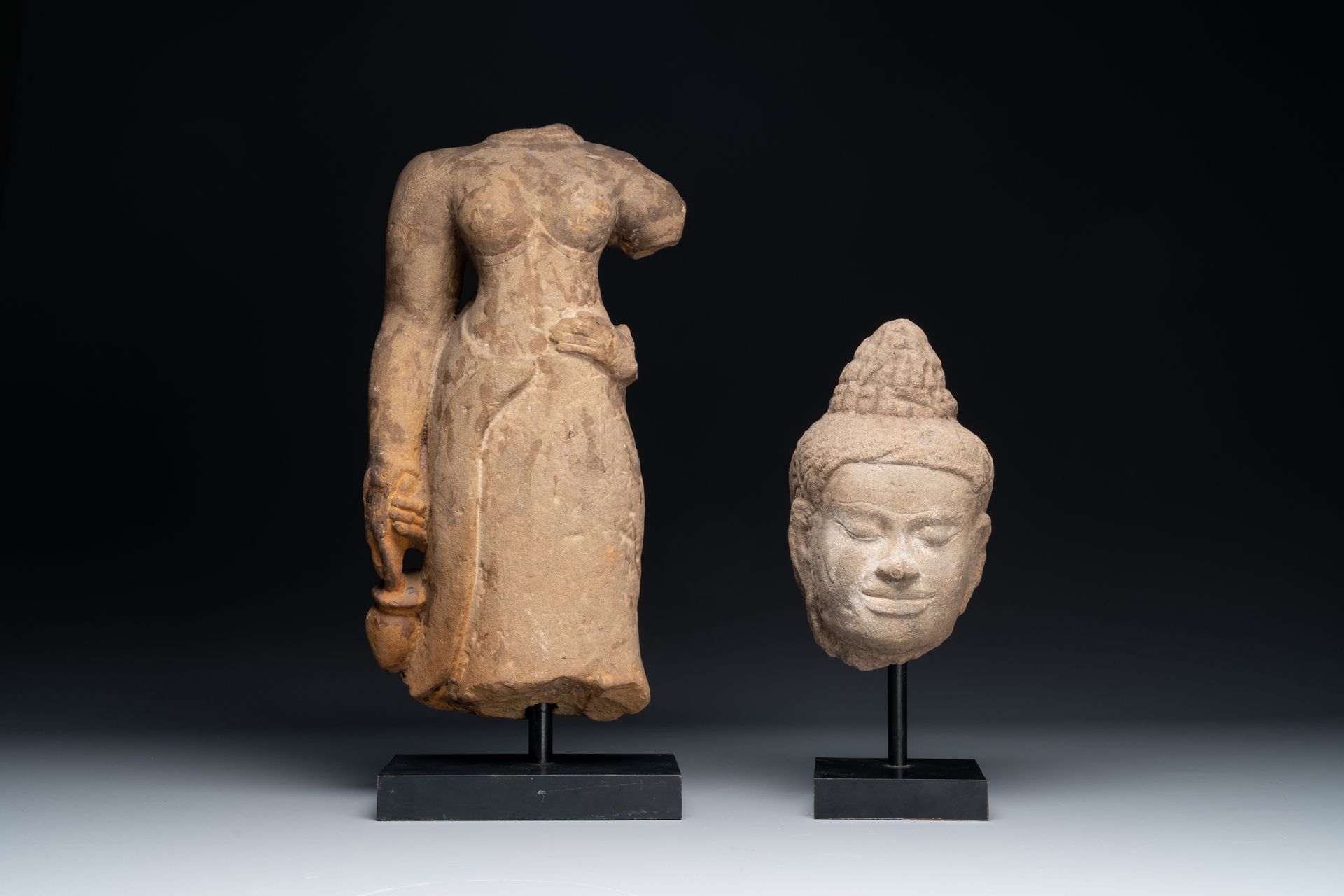 A sandstone female torso and a Buddha head, Cambodia, late Khmer period, 13/14th&hellip;