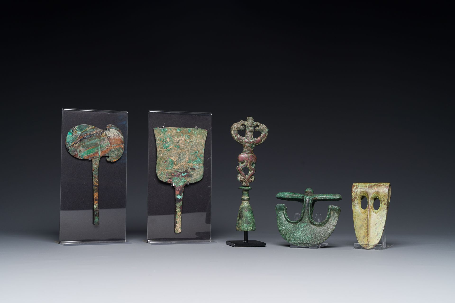 A collection of three bronze axes, a mirror and an anthropomorphic idol with two&hellip;