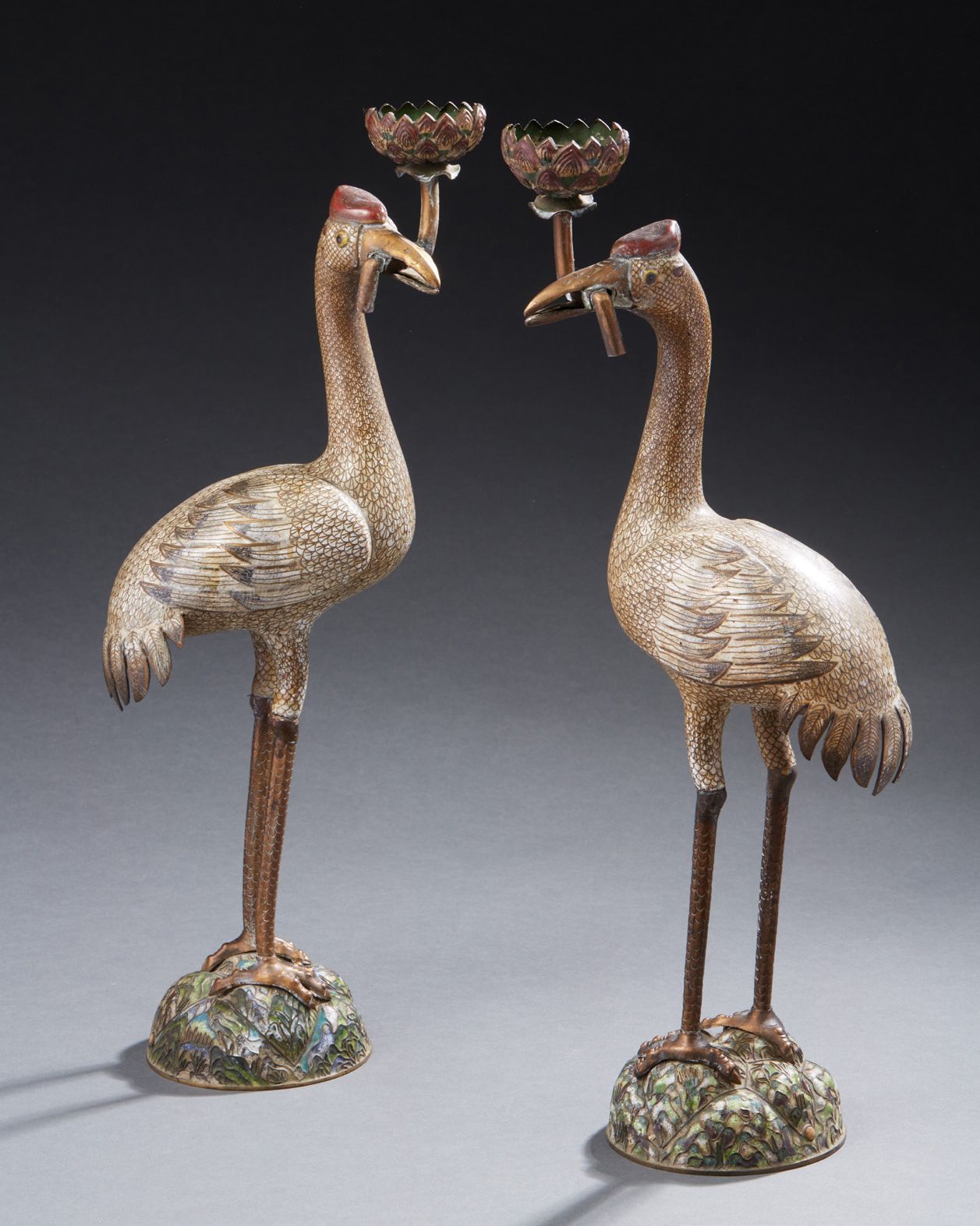 CHINE Pair of cloisonné bronze crowned cranes standing on mounds, a lotus branch&hellip;