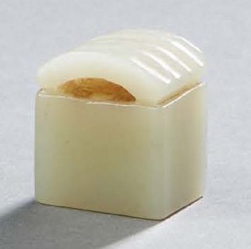 CHINE A small jade seal of quadrangular shape, the grip in a fluted arc. On the &hellip;