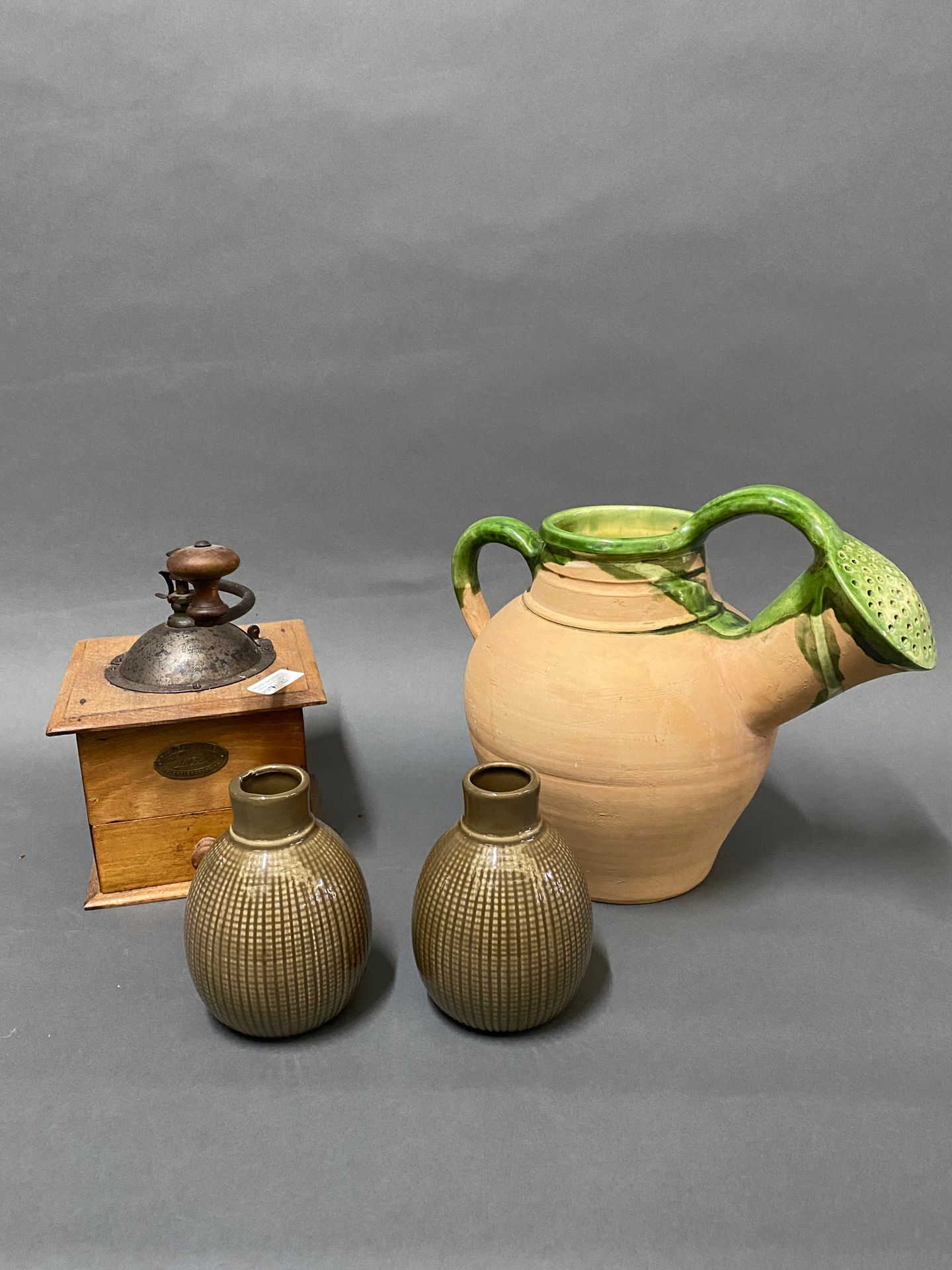 Null Set of various trinkets: coffee mill, watering can in glazed earth ...