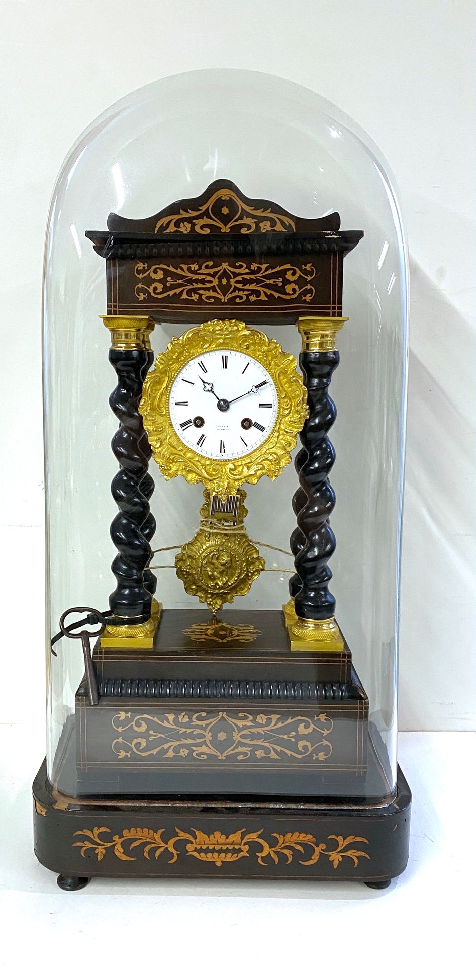 Null Clock with four twisted columns in blackened wood and gilded nets.

White e&hellip;