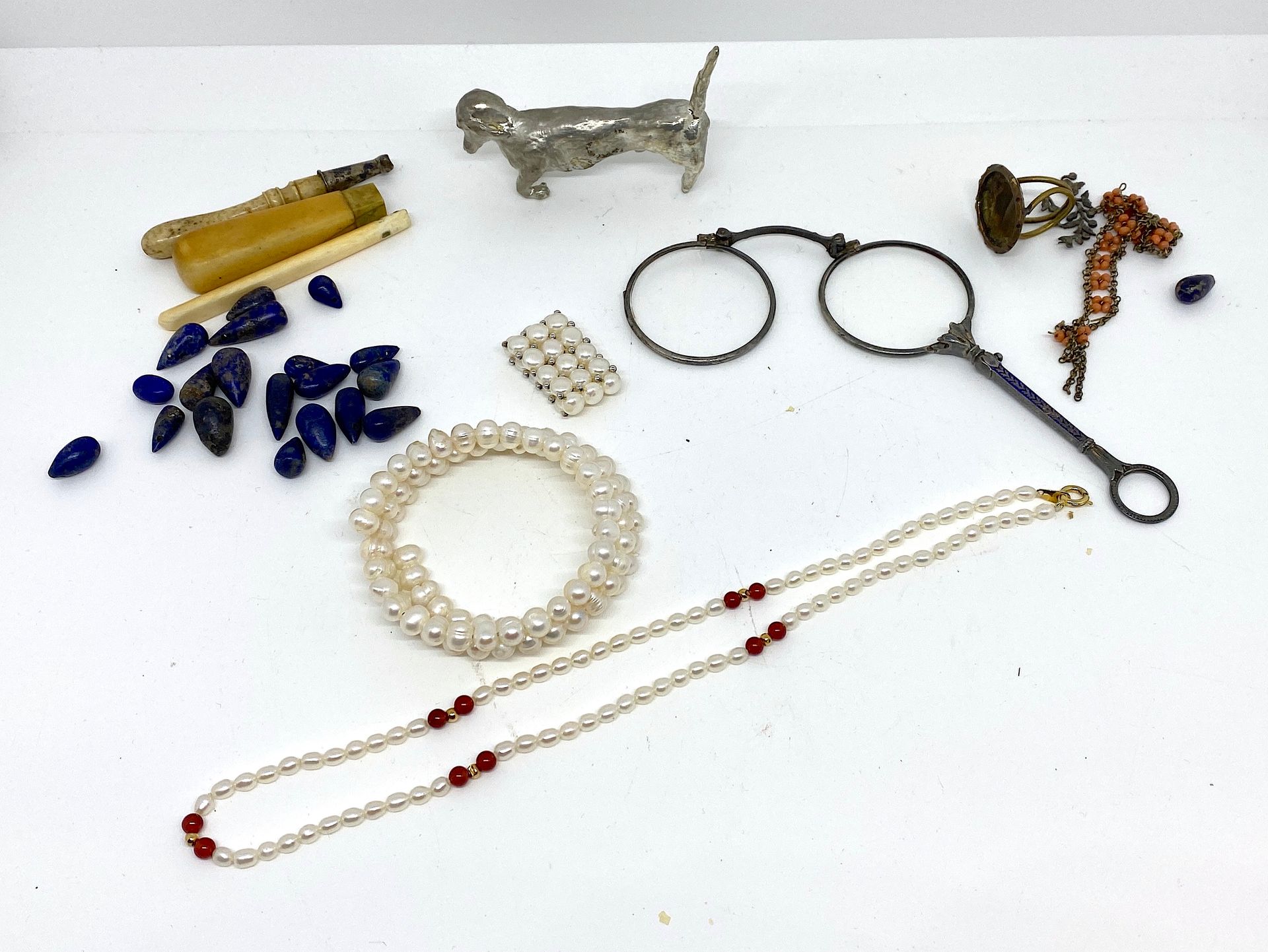 Null 杂项套装包括：:

- 青金石珠子

- 一套：养殖珍珠手镯、戒指和项链，一个长柄耳环。

- 象牙和骨质手柄

- 镀银腊肠犬小雕像

- 和各种