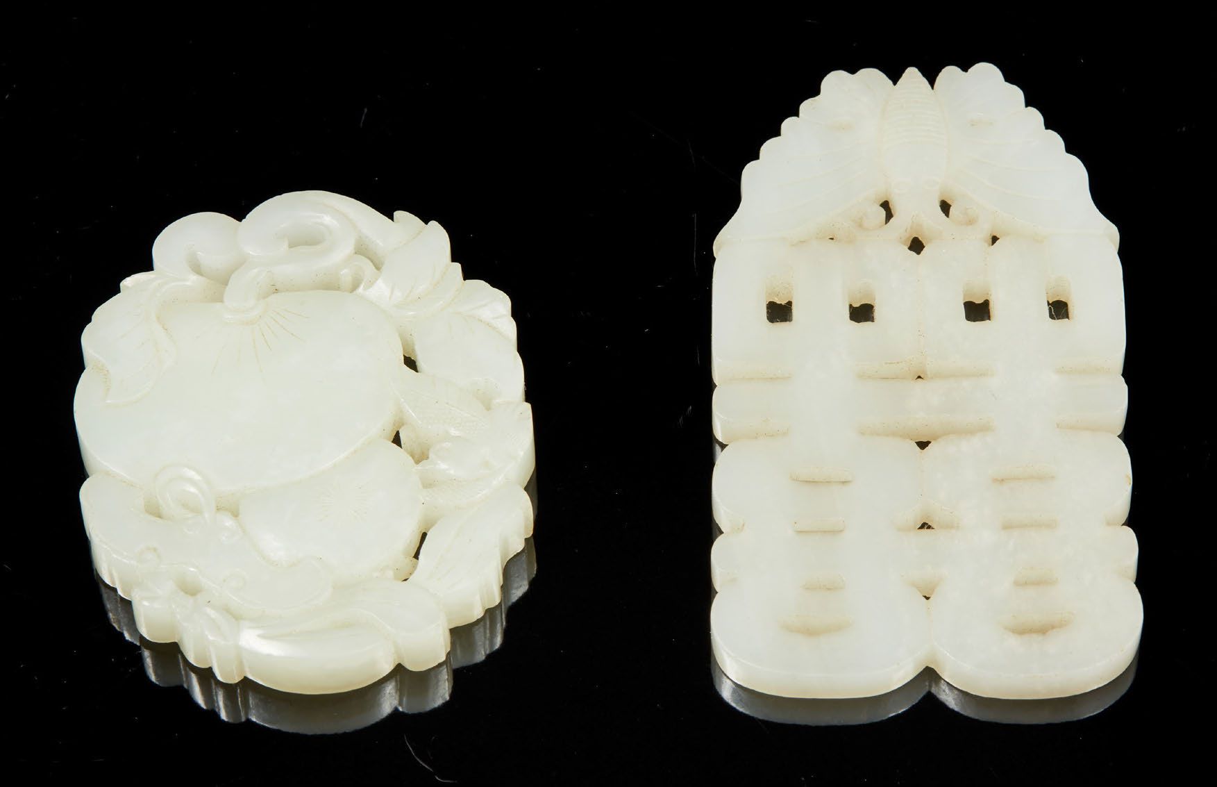 CHINE, XIXe siècle Two white jade pendants carved and openworked one of fruits, &hellip;