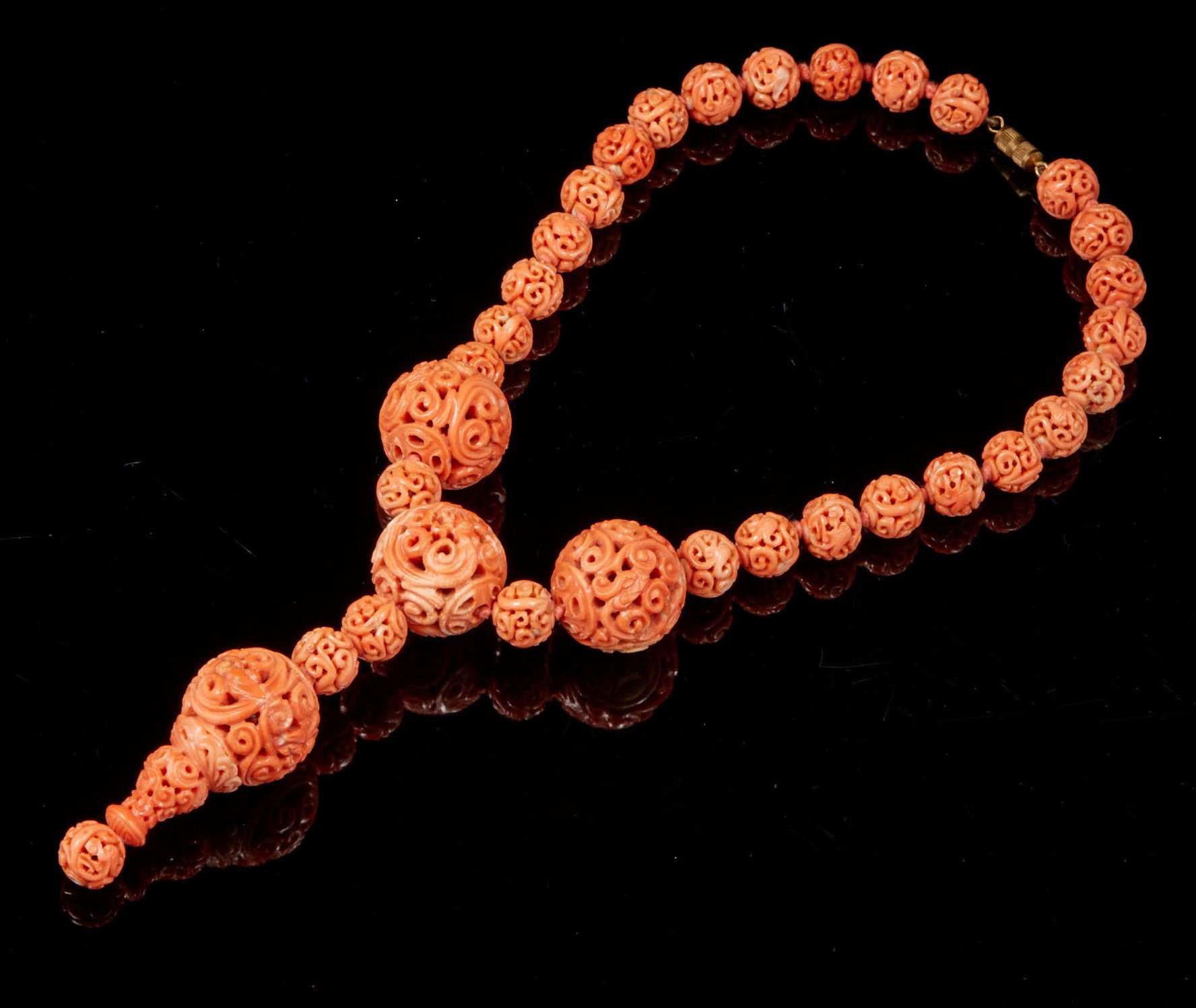 CHINE, vers 1900 由三十二颗雕刻和镂空的珊瑚珍珠组成的项链。
毛重：112,3克。