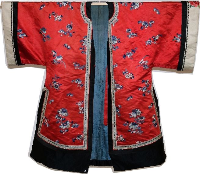 Null 中国，清朝，约1900年

汉族妇女的非正式服装



红色缎子上绣有蓝色单色的花朵和蝙蝠，黑色缎子辫子。绣有牡丹和蝴蝶的奶油色缎面袖子，蓝色塔夫绸的&hellip;