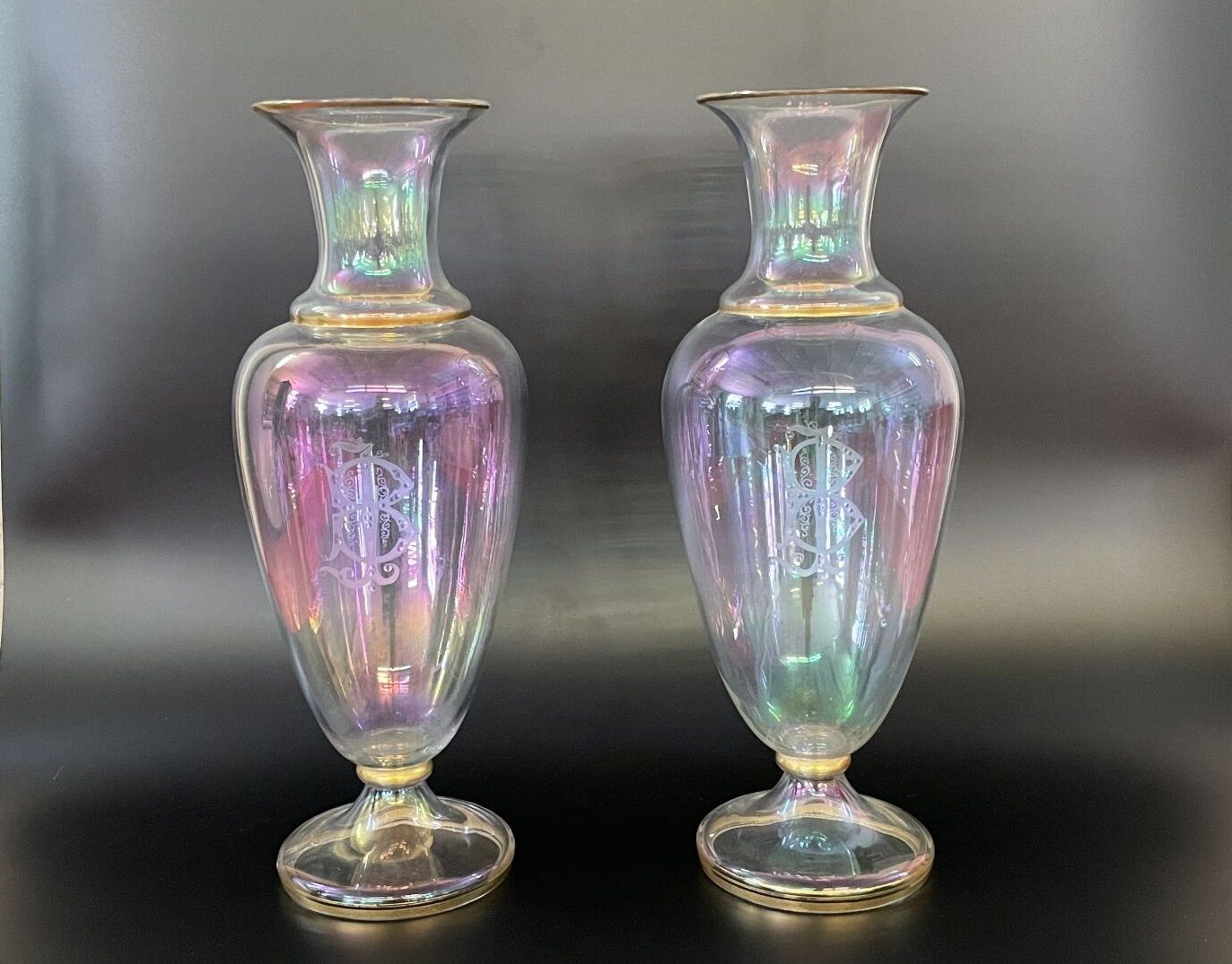 Null 一对彩虹色的半透明玻璃花瓶，"肥皂泡 "风格，颈部外翻，刻有数字B.I.，下有金色边框。

19世纪晚期。

高：41厘米。