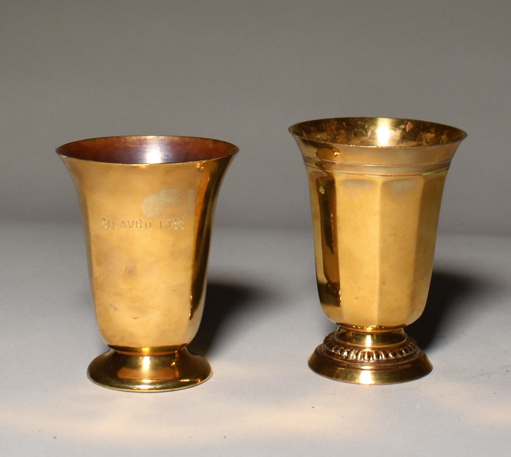 Null TWO GOLDEN METAL TIMBALS on pedestal, one dated "30 April 1935". Height 10 &hellip;