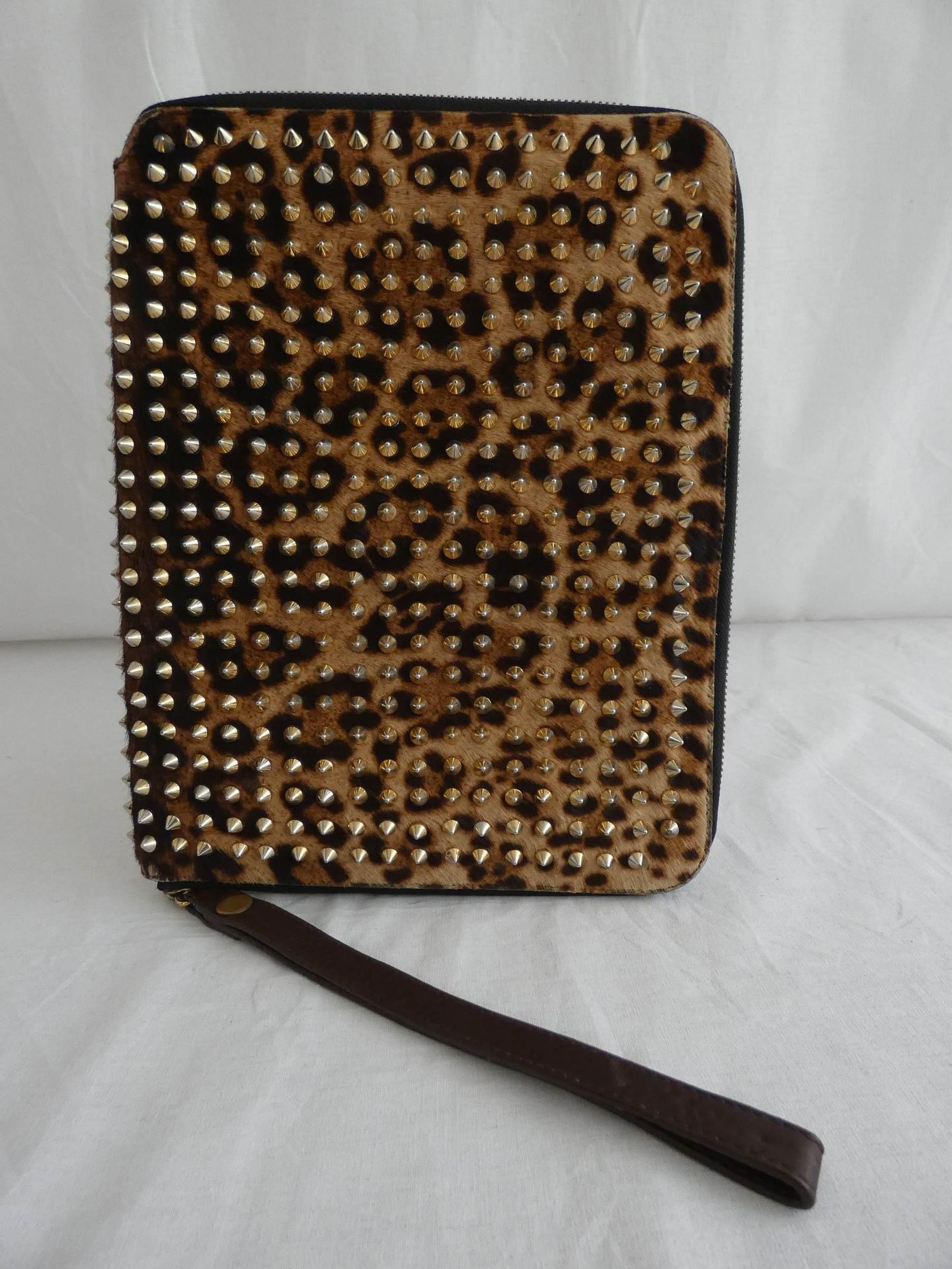 Null 
	Christian LOUBOUTIN

Panther print cowhide Ipad clutch with gold metal st&hellip;