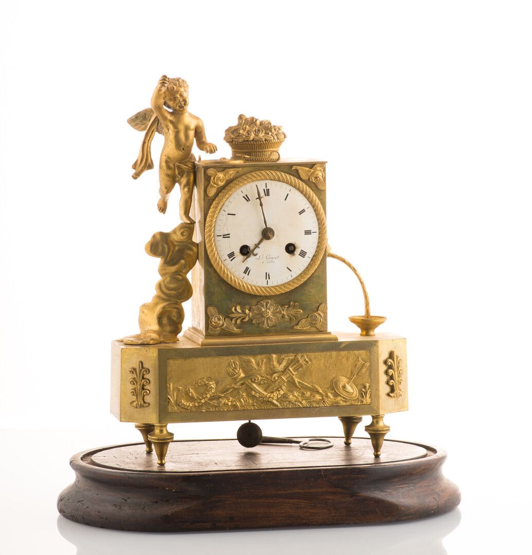 Null 一座带凹槽和镀金的青铜钟，带罗马数字的珐琅表盘上有 "L. Gamot / à Lille "的字样，装饰有一个带翅膀的普托，一个玫瑰花篮和一个带狮子&hellip;