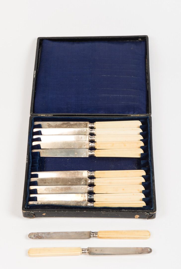 Null 一套12把水果刀，Minerve标记的银质刀身，象牙手柄。Goldsmith：GA。在其标有CP的盒子里（毛重：360克）（有小裂纹）。