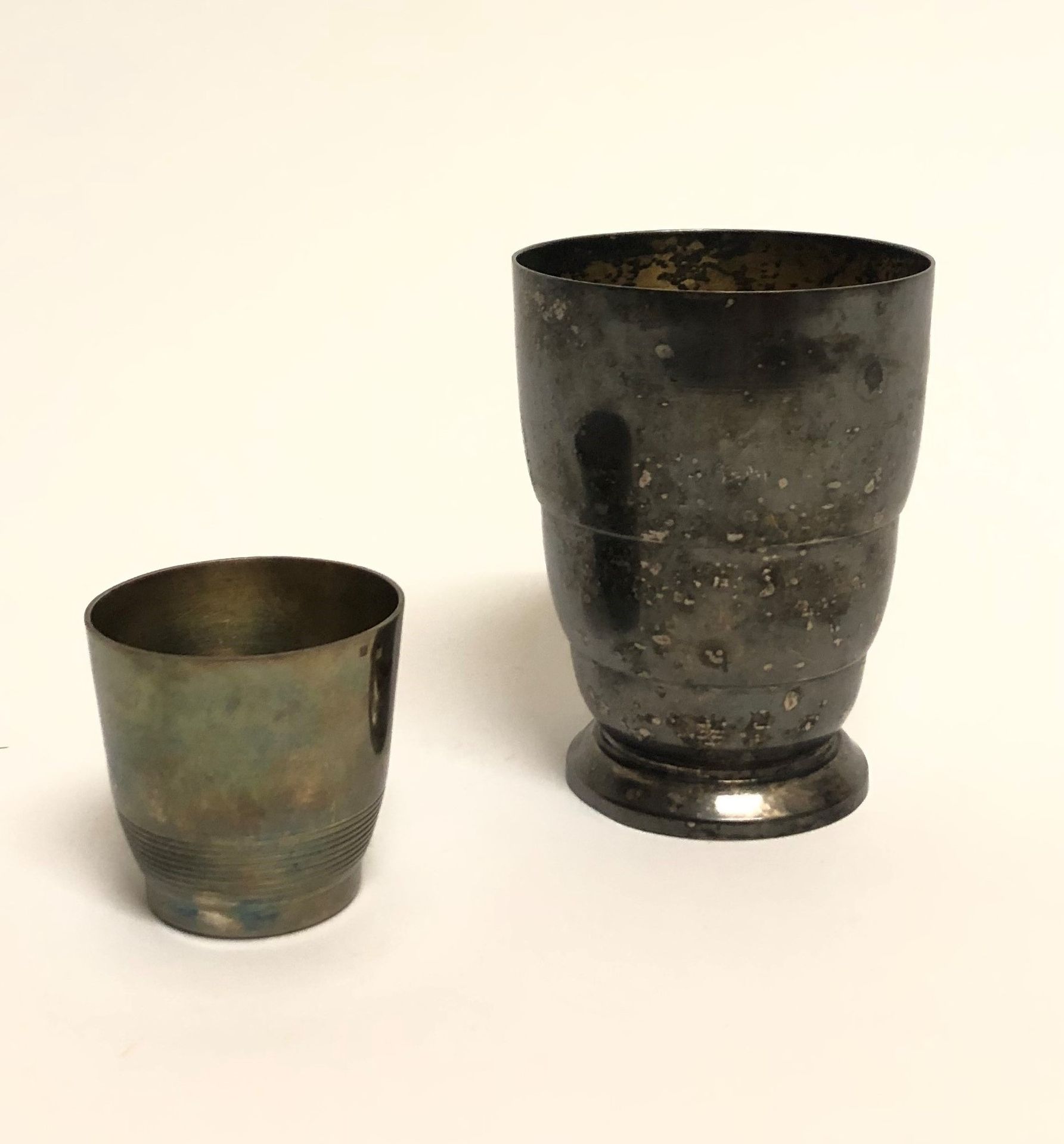 Null 包括一个小的银质利口酒杯和一个有渔夫装饰的镀银水瓶。高度：4.3和8.7厘米。4,3和8,7厘米。