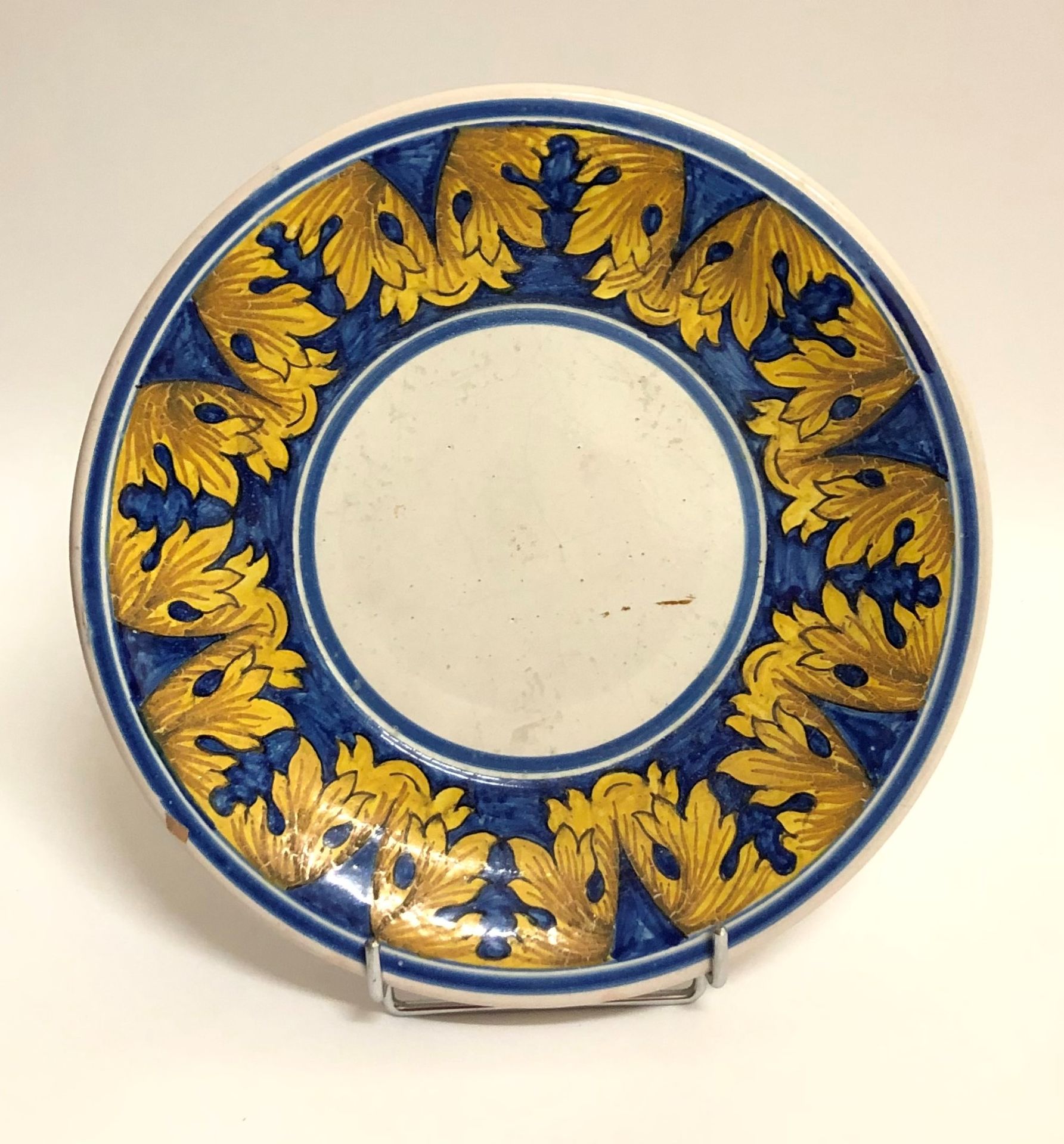 Null Plate in enamelled earthenware decorated with acanthus leaves on a blue bac&hellip;