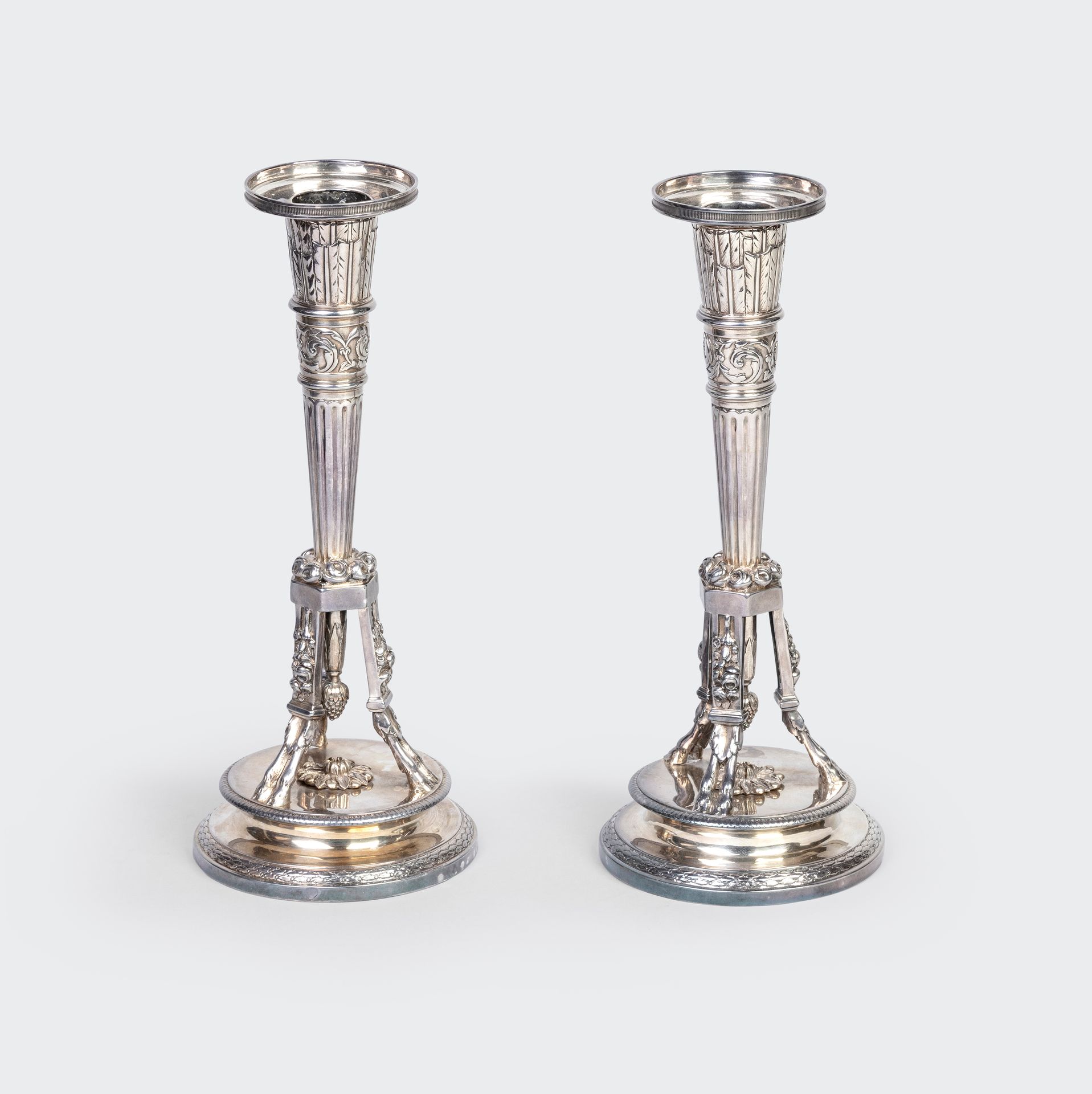 Null Pair of silver candlesticks of quiver form with chased decoration of a leaf&hellip;