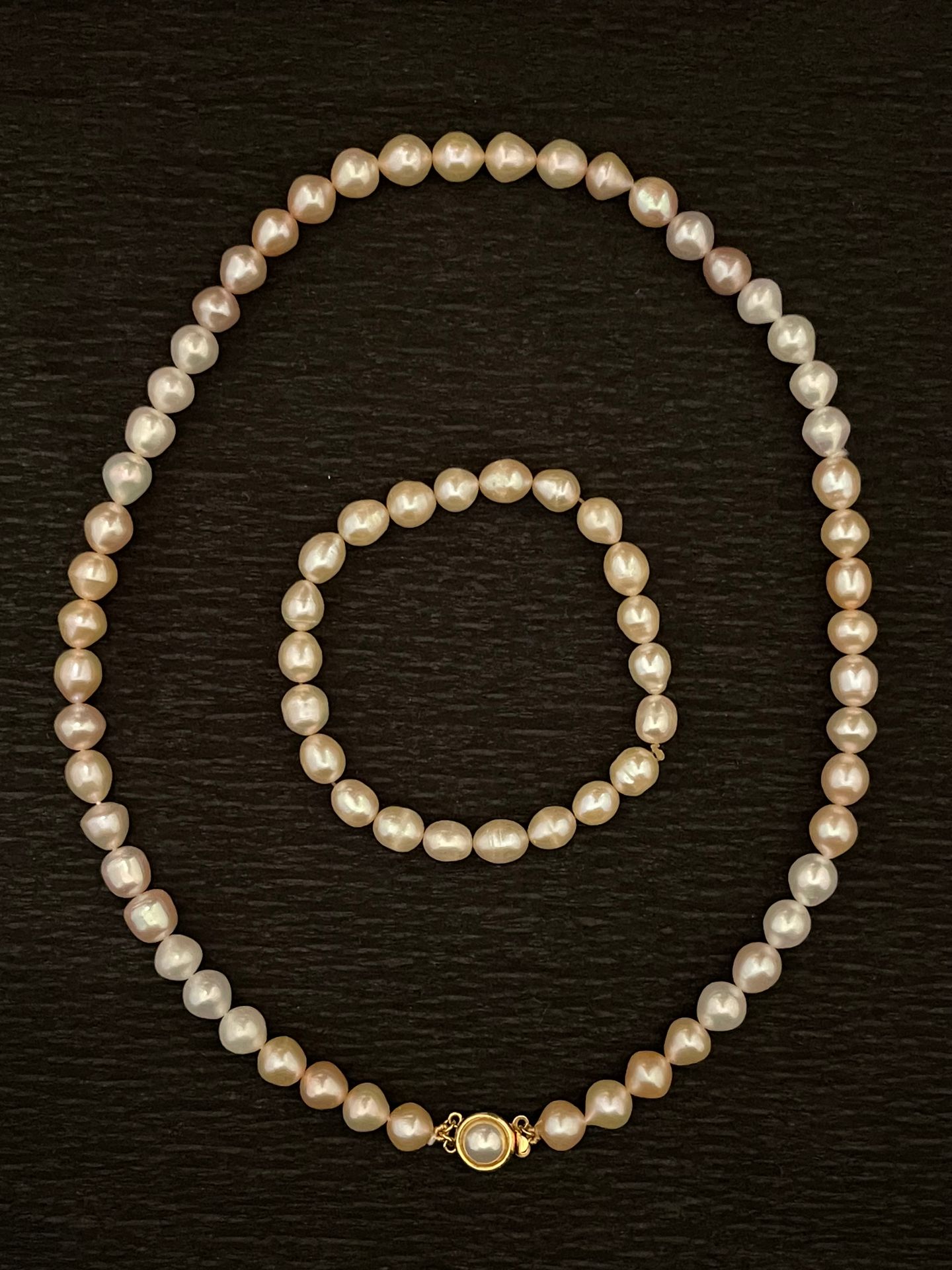 Null Lot including: a pink freshwater pearl necklace, and matching bracelet.