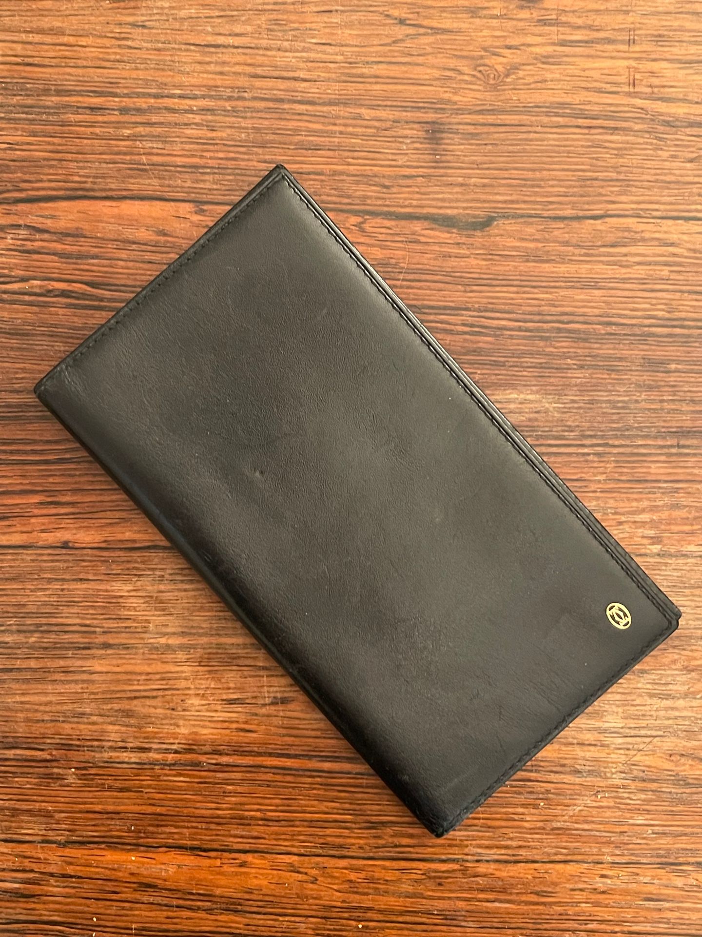 CARTIER Paris. Black leather wallet, signed. Dim: 17 x 9…