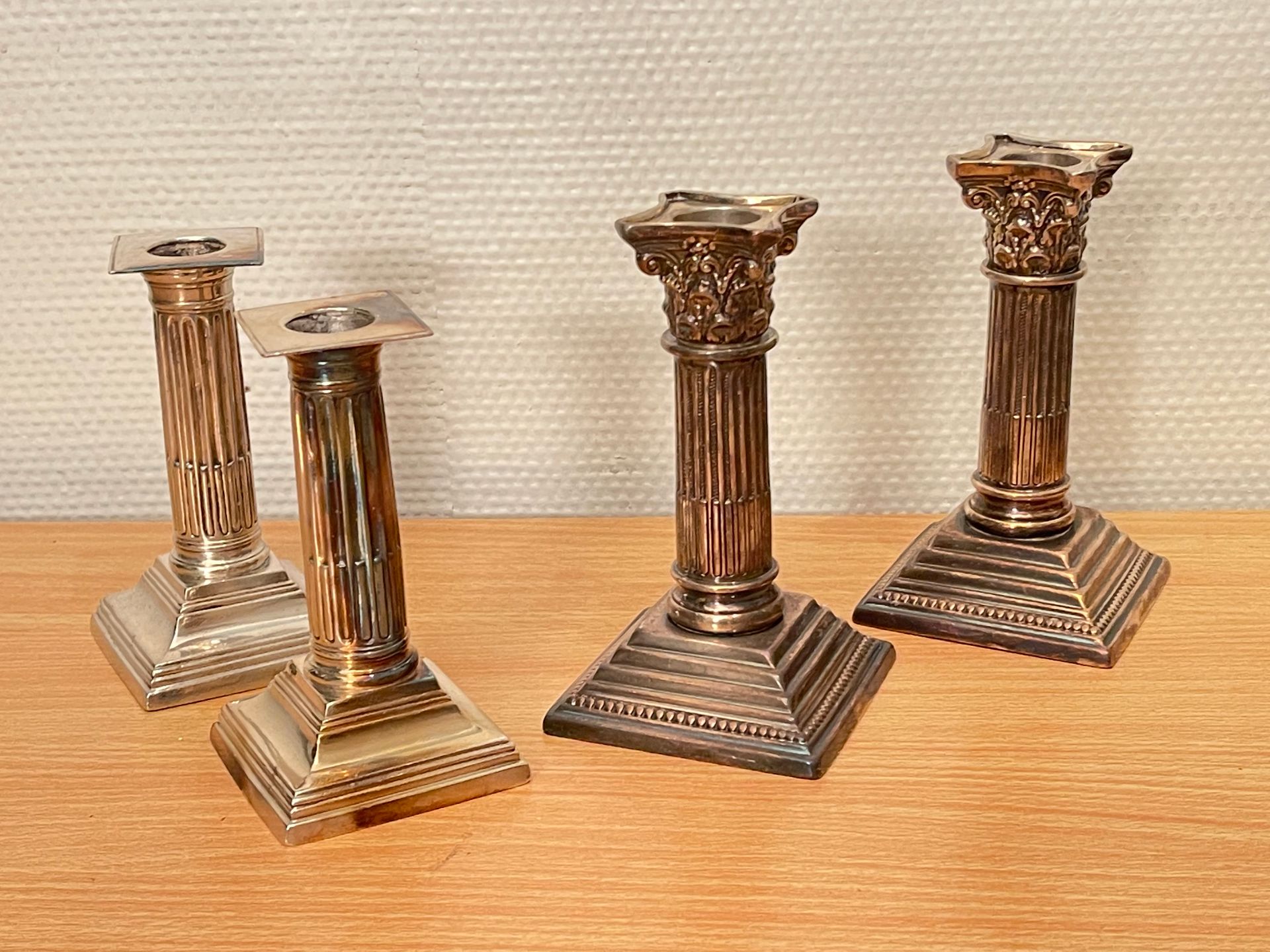 Null Two pairs of silver-plated candlesticks with fluted shafts, one topped with&hellip;