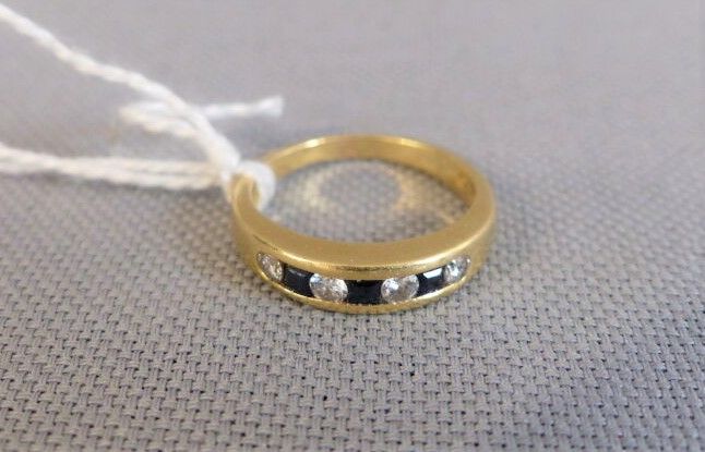Null Yellow gold ring set with diamonds and sapphire in line.

Weight : 4,3 g.

&hellip;