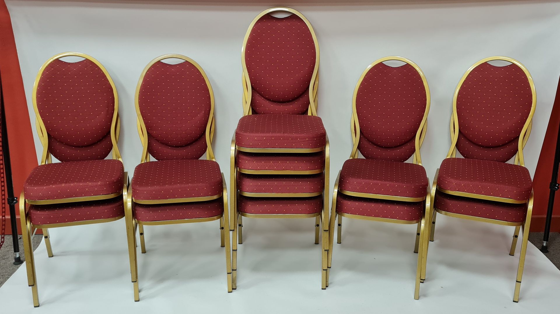 Null lote 20 sillas apilables con asientos de tela roja y patas de metal
