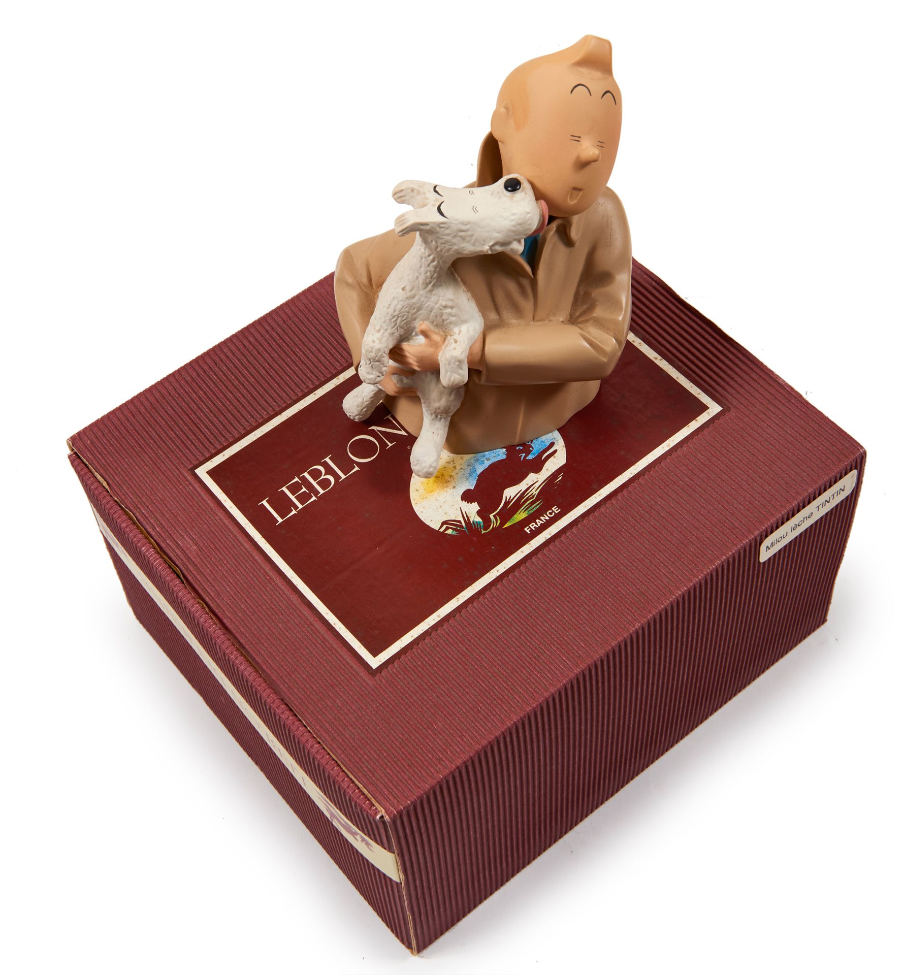 Leblon-Delienne - Snowy licking Tintin : Figurine representing Snowy in Tintin's&hellip;