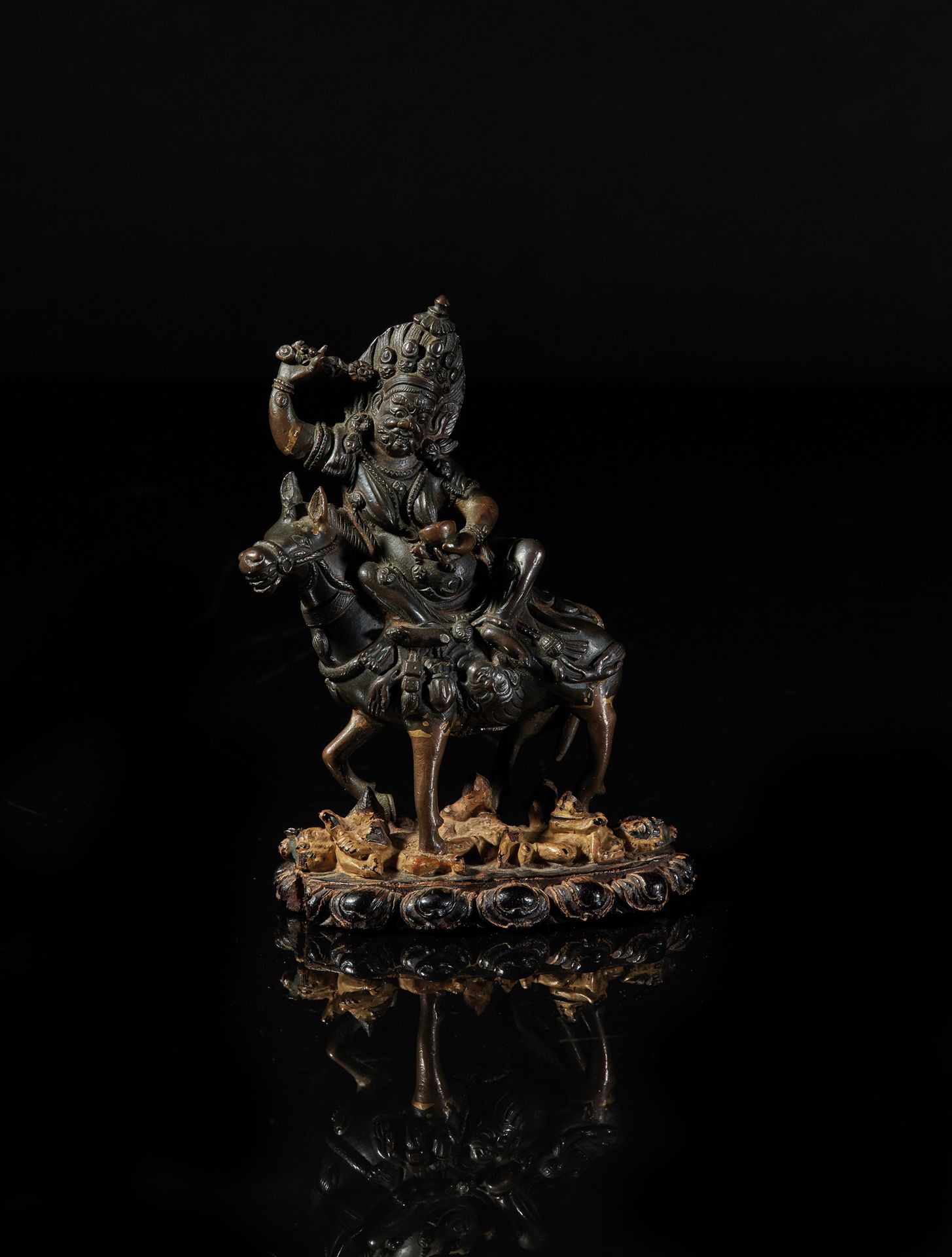 TIBET - XVIIIe siècle 一尊棕色铜锈的斯里德维坐在骡子上，手持卡帕拉（修复物）的铜像。金漆木质底座显示了莲花楣上的血池中的恶魔。
总高度11&hellip;