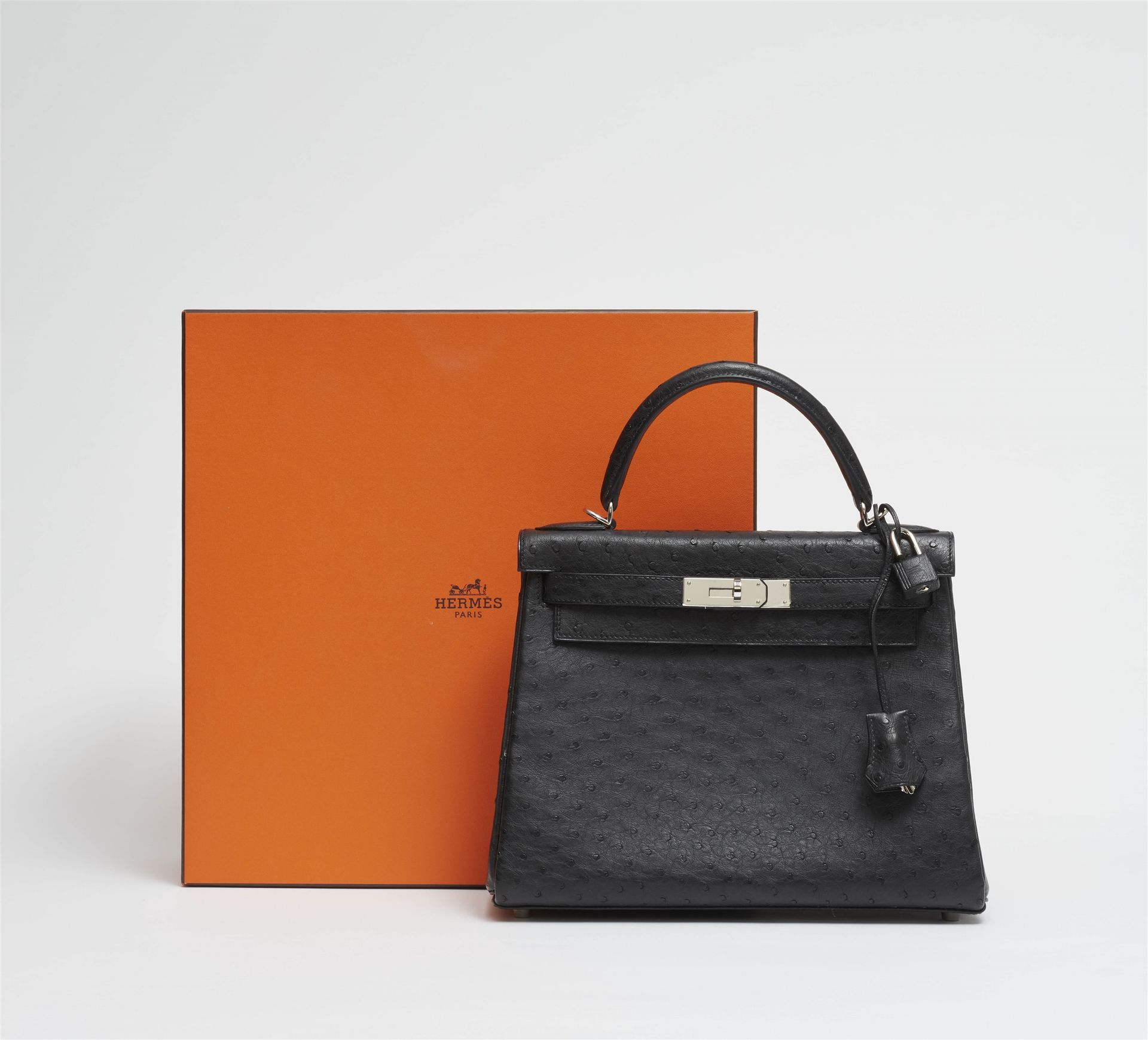 A black ostrich leather Hermès Kelly bag 28 with silver …