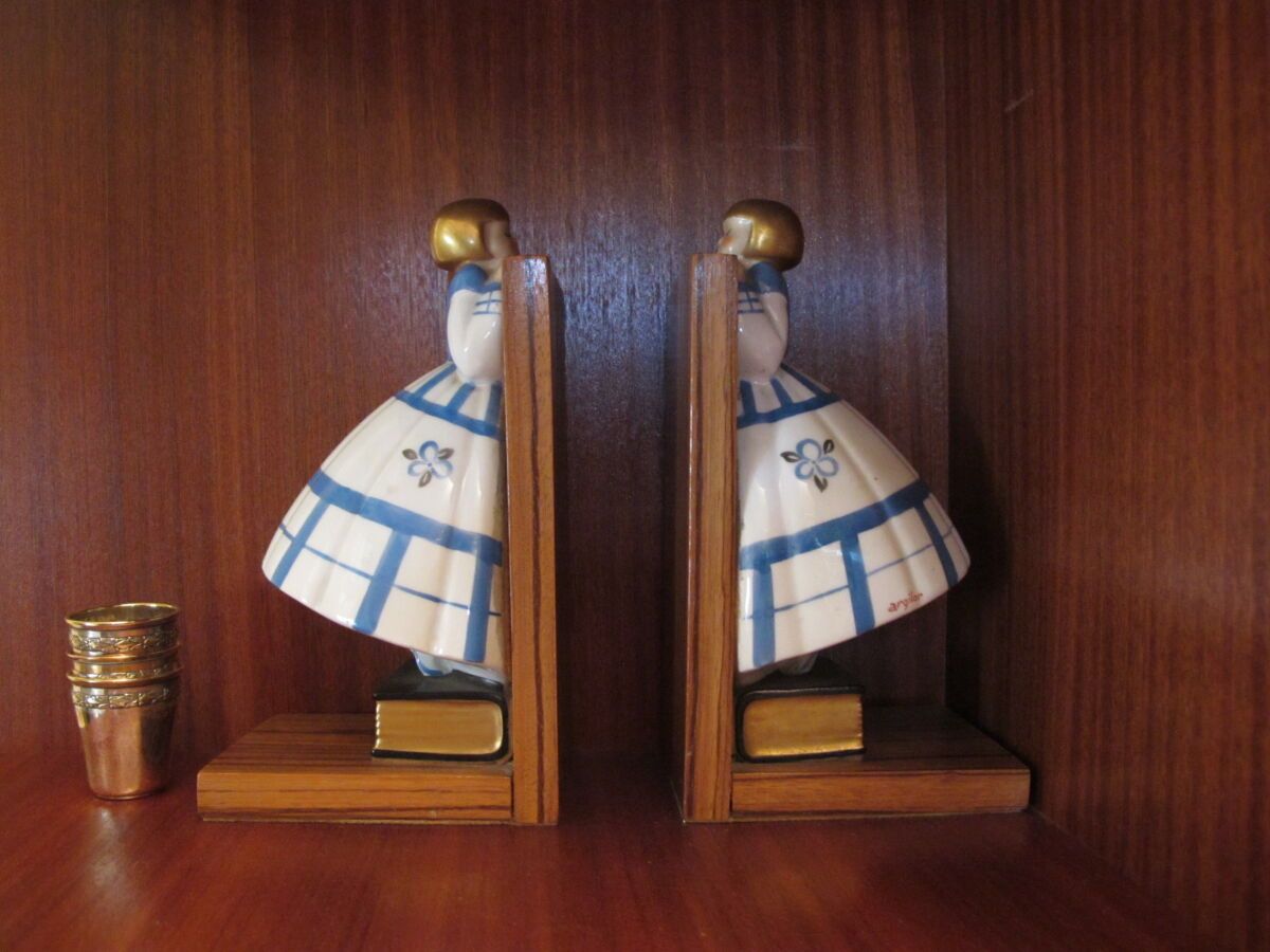 Null Pair of bookends in wood and enameled porcelain each featuring a girl stand&hellip;